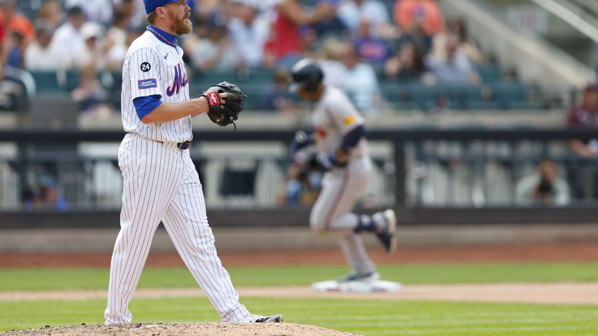 New York Mets relief pitcher Jake Diekman stares into the outfield as Atlanta Braves' Ramón Laureano rounds third base after hitting a two-run home run in the eighth inning of a baseball game Sunday, July 28, 2024, in New York.