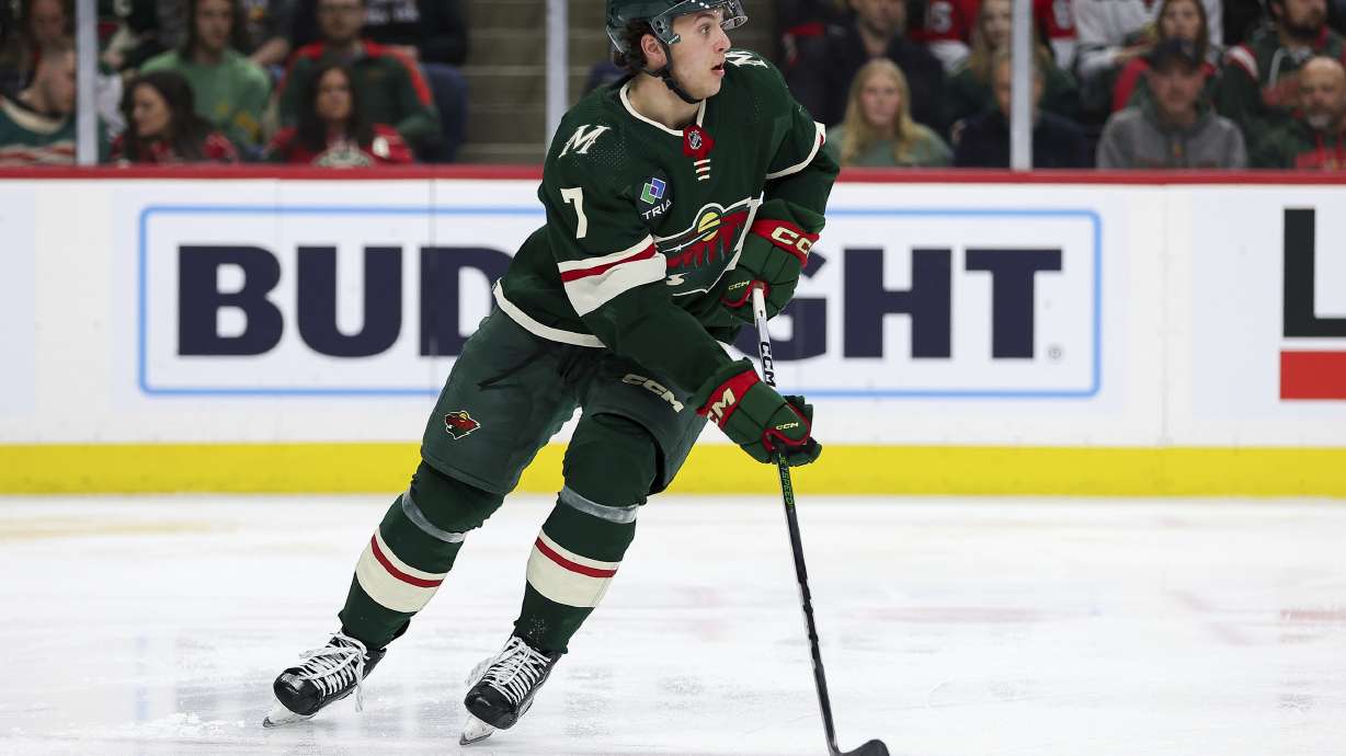 FILE - Minnesota Wild defenseman Brock Faber skates with the puck during the second period of an NHL hockey game against the Ottawa Senators Tuesday, April 2, 2024, in St. Paul, Minn. Minnesota Wild general manager Bill Guerin saw enough potential in Brock Faber's rookie season to sign the defenseman to an eight-year, $68 million contract extension on Monday, July 29, 2024.