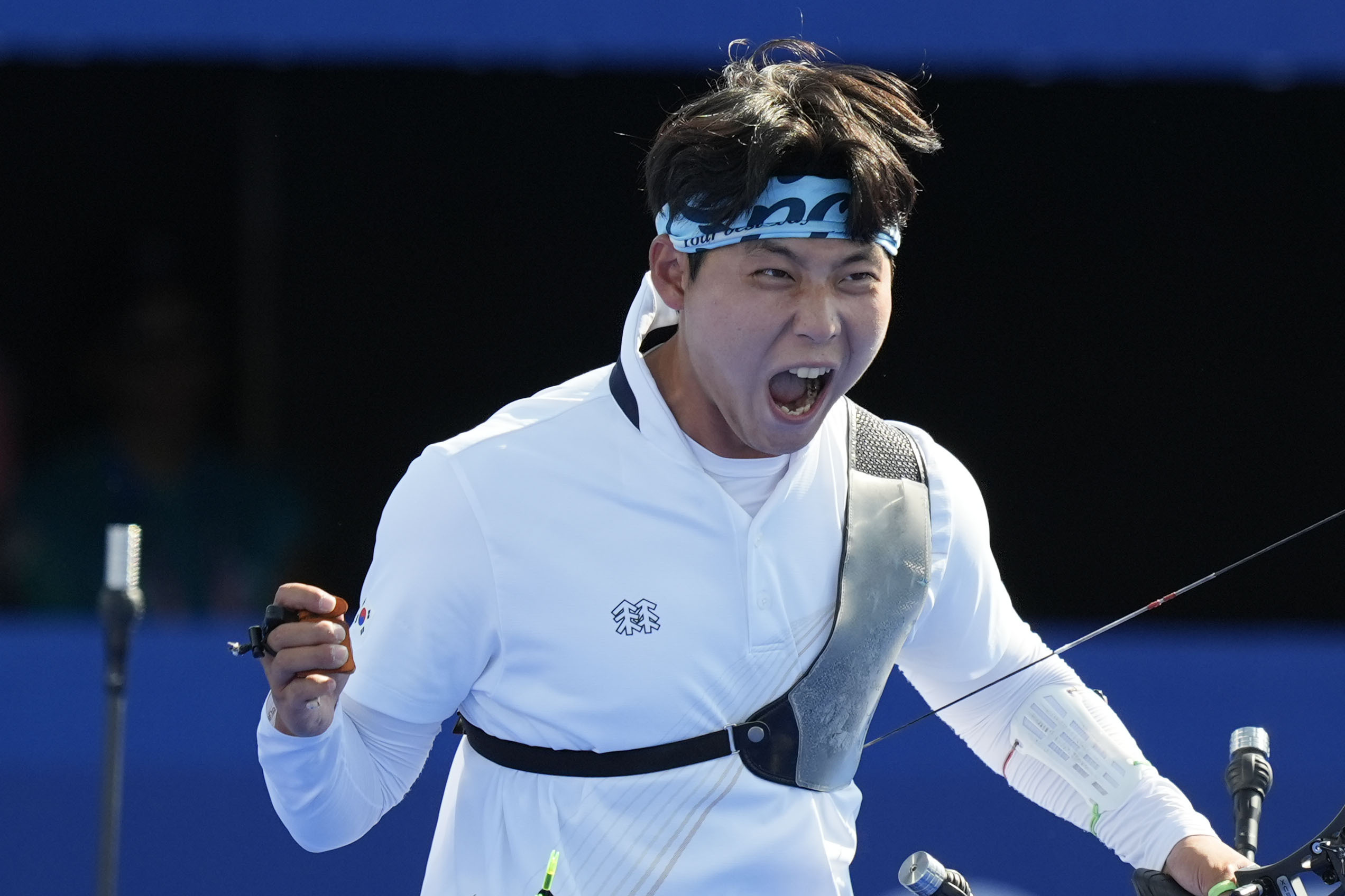 South Korea's Wooseok Lee celebrates with after a win during the men's team gold medal match Archery competition against France at the 2024 Summer Olympics, Monday, July 29, 2024, in Paris, France.