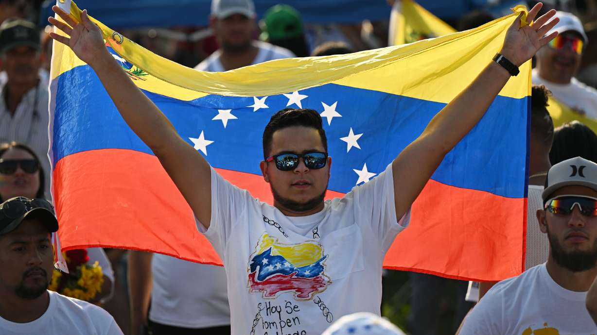 The growth of Utah's Venezuelan population outpaces expansion from other countries, data released last week shows. In the July 28 photo, a man holds up a Venezuelan flag at a gathering in Herriman to mark the presidential election in Venezuela.