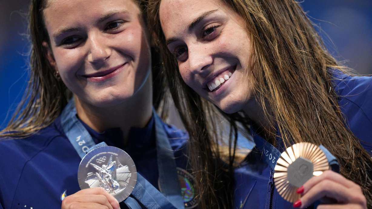 Silver medalist, Katie Grimes, left, of the United States, left, stands with compatriot and bronze medalist Emma Weyant after the women's 400-meter individual medley final at the 2024 Summer Olympics, Monday, July 29, 2024, in Nanterre, France.