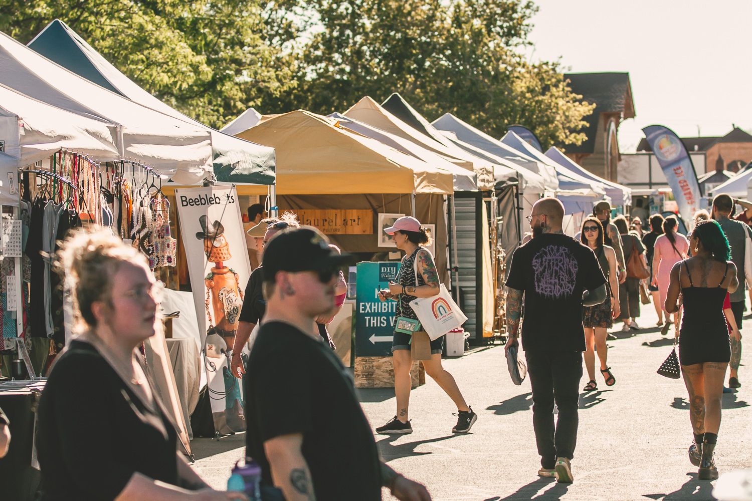 People walk past vendor booths at Craft Lake City, an annual DIY festival the second weekend in August at the Utah State Fairpark.