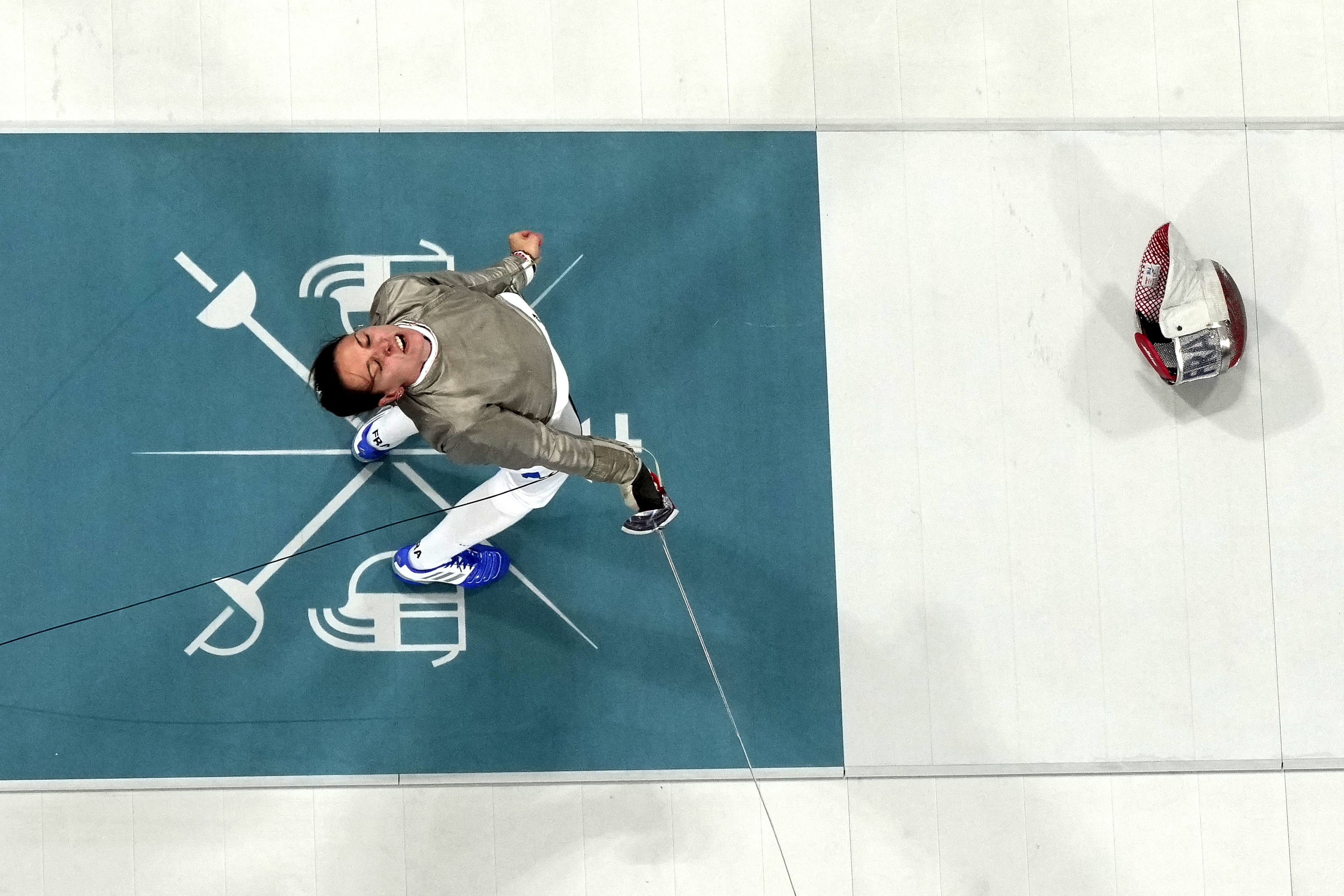 France's Manon Apithy Brunet celebrates after winning the women's individual Sabre quarterfinal match against Greece's Theodora Gkountoura at the 2024 Summer Olympics, Monday, July 29, 2024, in Paris, France. 