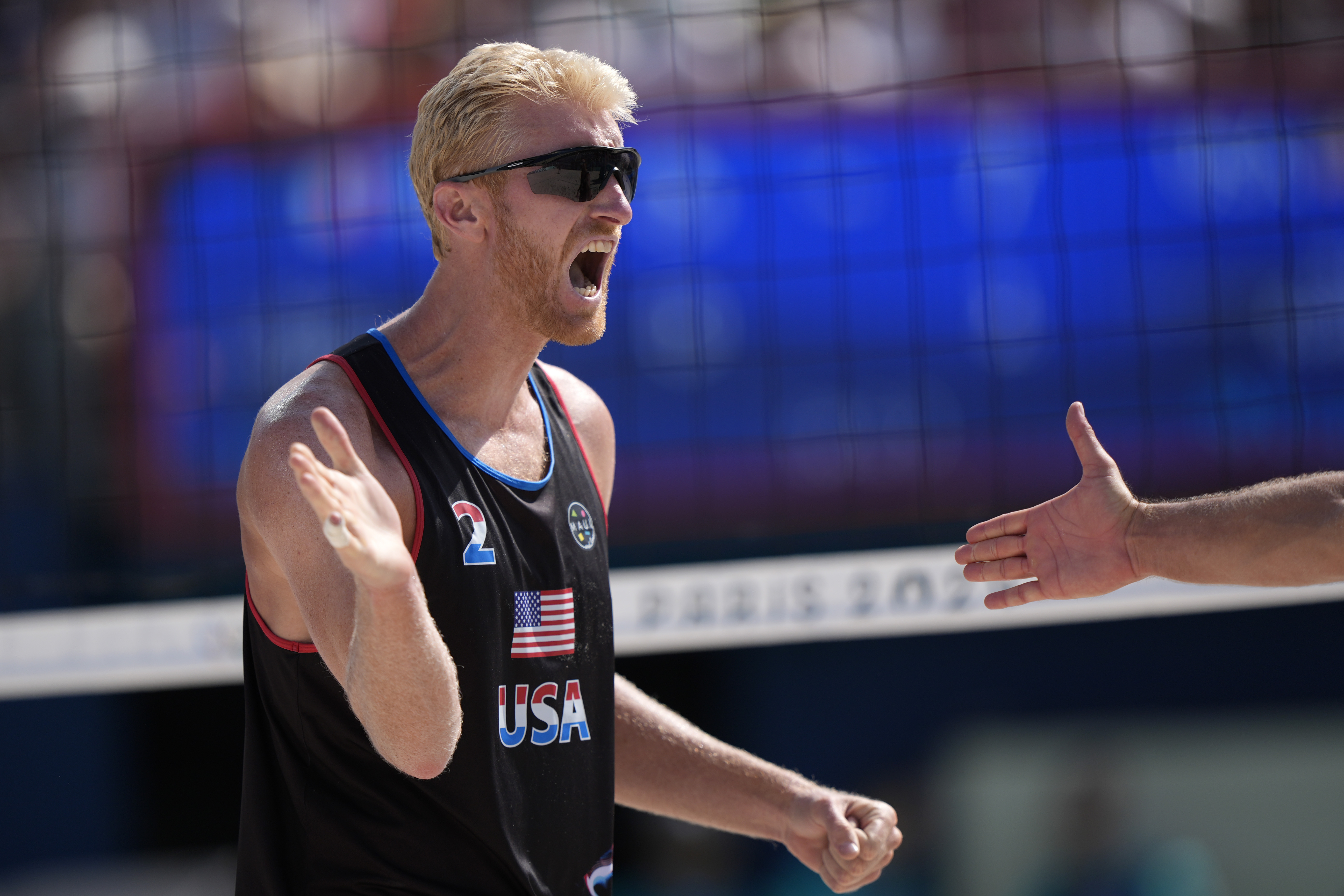 United States' Chase Budinger celebrates a point against France in a beach volleyball match at the 2024 Summer Olympics, Monday, July 29, 2024, in Paris, France. 