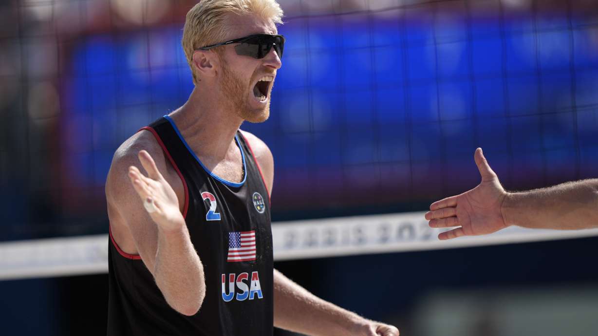 United States' Chase Budinger celebrates a point against France in a beach volleyball match at the 2024 Summer Olympics, Monday, July 29, 2024, in Paris, France.