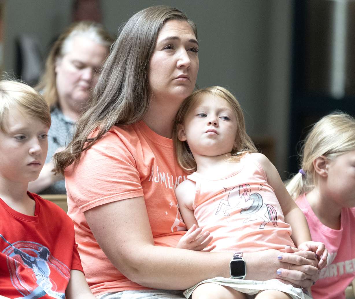 PTA President Sharon Stanley holds her daughter Jane, 3, on her lap while listening to a Jordan School District’s press conference announcing that the district has been selected as one of the lead plaintiffs in a federal multidistrict lawsuit against multiple social media companies accusing them of negligence and public nuisance, in West Jordan on Monday.