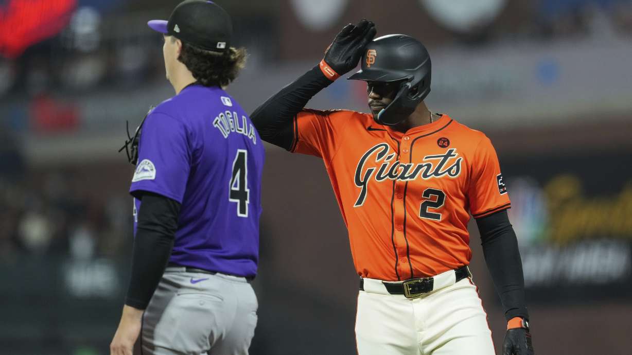 San Francisco Giants' Jorge Soler, right, celebrates next to Colorado Rockies first baseman Michael Toglia, left, after hitting an RBI single during the fourth inning of a baseball game Friday, July 26, 2024, in San Francisco.