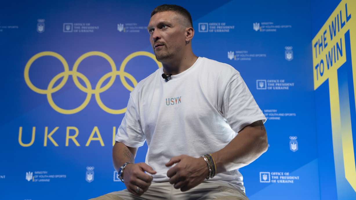 World Heavyweight boxing champion Oleksandr Usyk speaks during a visit to the Ukrainian House in Paris, France at the 2024 Summer Olympics, Monday, July 29, 2024. Usyk has come to Paris to support Ukrainian athletes at the Olympics amid war at home.