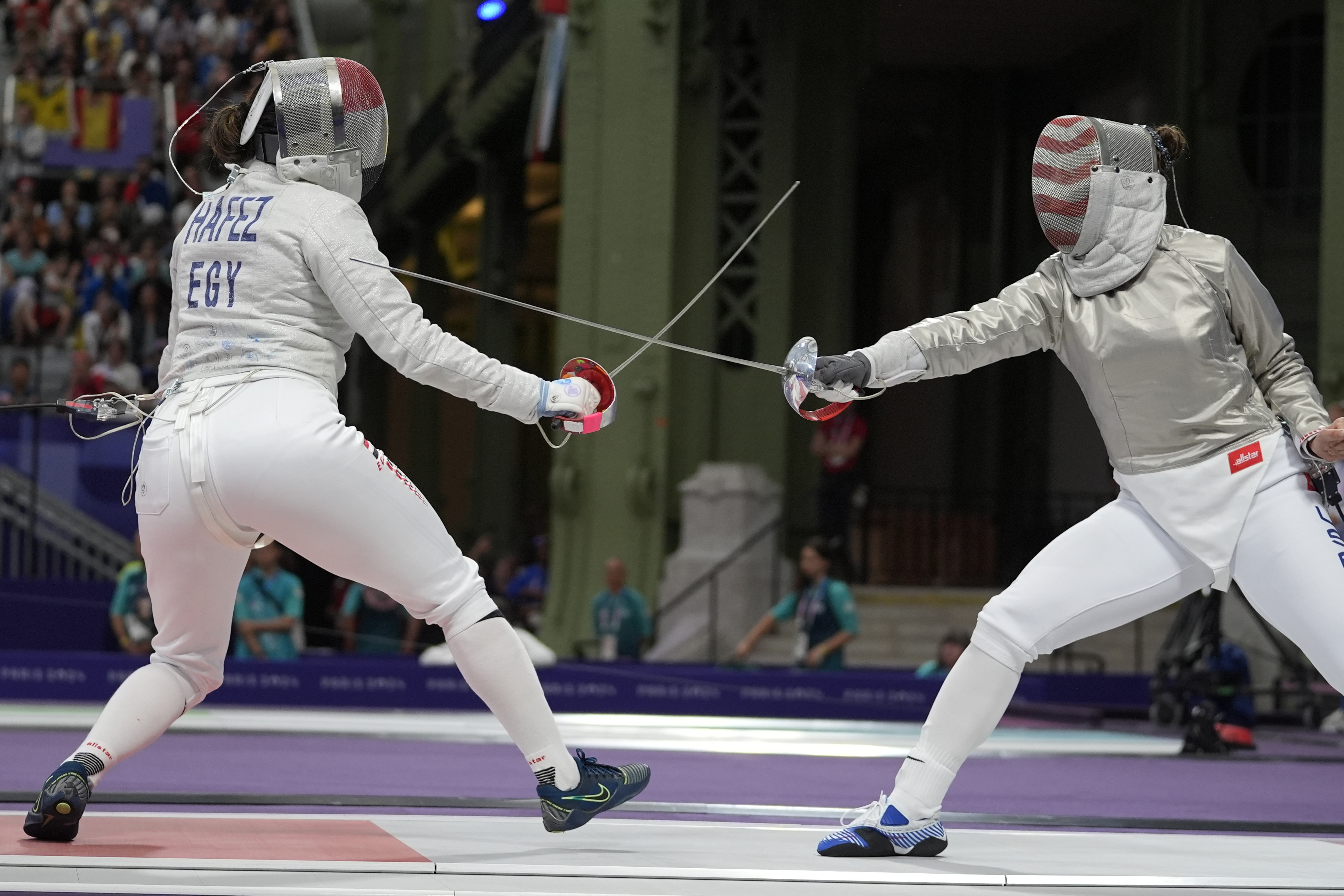 Egypt's Nada Hafez and United States' Elizabeth Tartakovsky compete in the women's individual Sabre round of 32 competition during the 2024 Summer Olympics at the Grand Palais, Monday, July 29, 2024, in Paris, France.