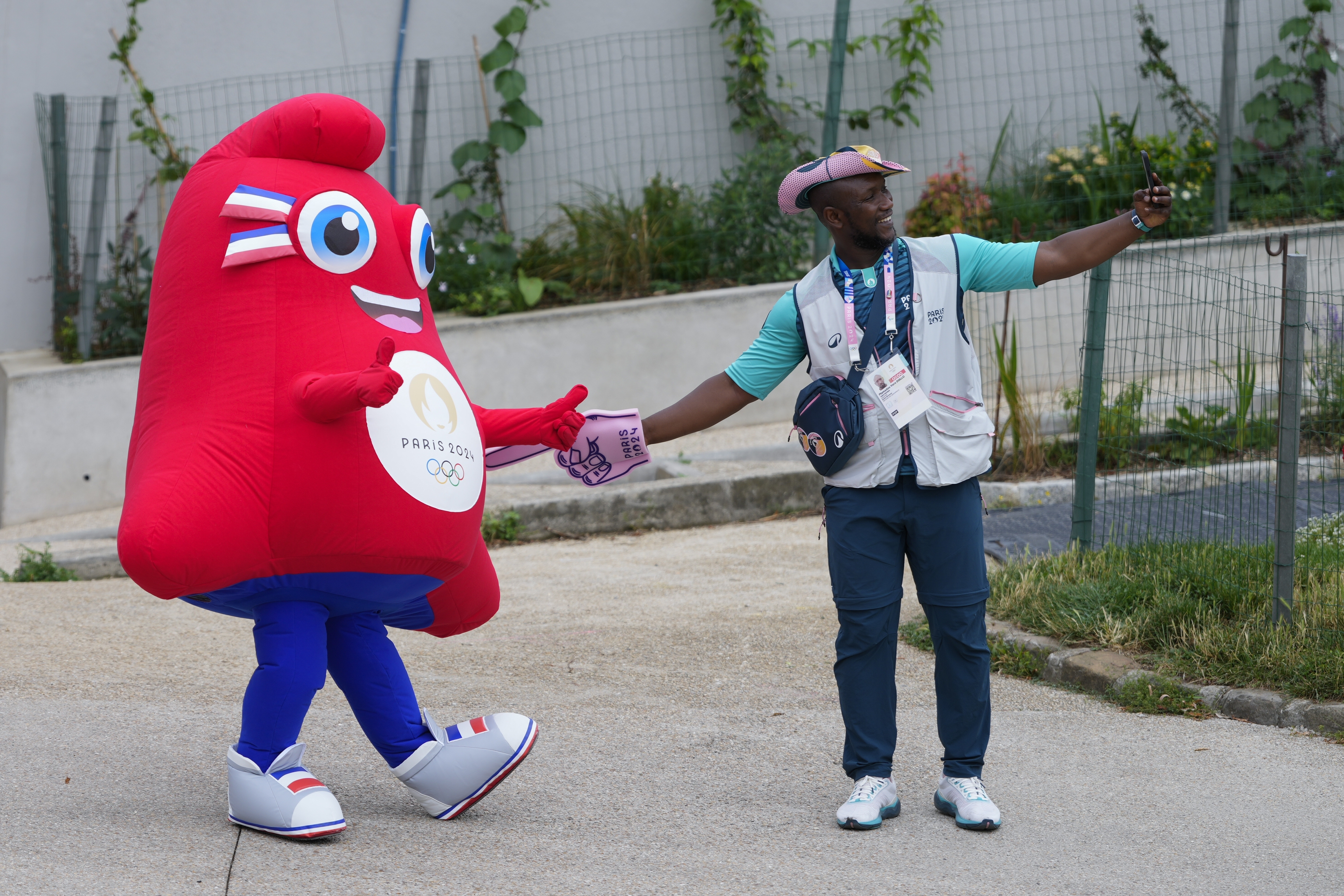 The Olympic Phryge, left, the mascot, poses with Mamadou Yero Diallo in Paris, France, ahead of the opening ceremony of the 2024 Summer Olympics, Friday, July 26, 2024. 