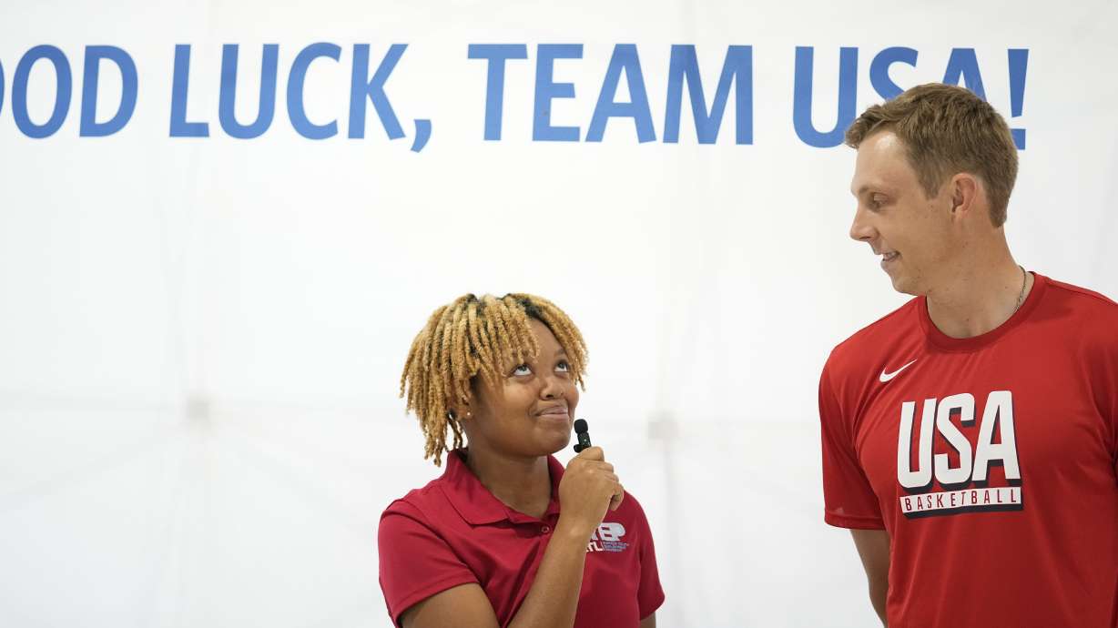 Team USA basketball athlete, Canyon Barry, talks with people before departing from the airport on Wednesday, July 17, 2024, in Atlanta.