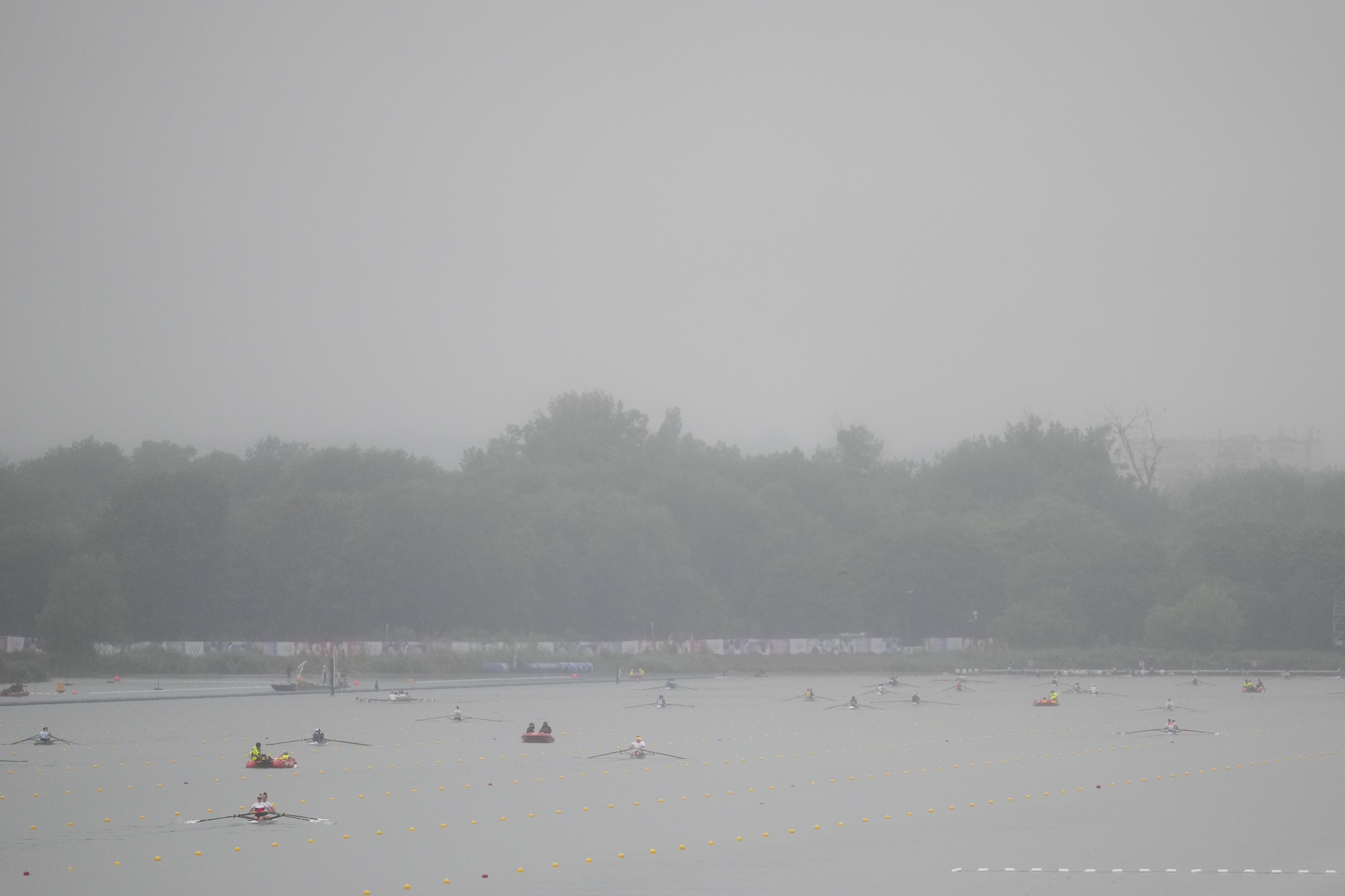 Rowers warm up ahead of competition on a rainy day at the 2024 Summer Olympics, Saturday, July 27, 2024, in Vaires-sur-Marne, France. 