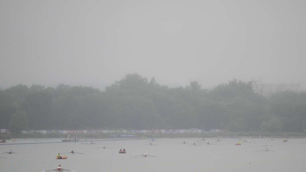 Rowers warm up ahead of competition on a rainy day at the 2024 Summer Olympics, Saturday, July 27, 2024, in Vaires-sur-Marne, France.