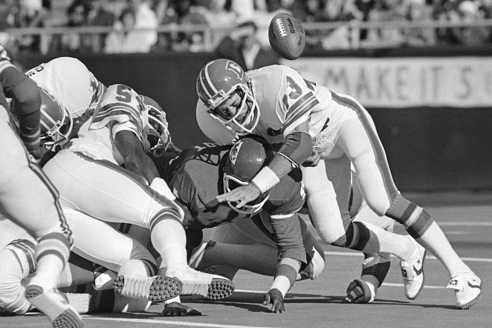 FILE - Kansas City Chiefs running back James Hadnot, bottom, loses the football after being hit by Denver Broncos linebacker Randy Gradishar, right, in the second quarter of an NFL football game, Sunday, Oct. 18, 1981 in Kansas City, Mo. Gradishar is the first member of the Broncos' famed “Orange Crush” defense to be enshrined in the Pro Football Hall of Fame. 