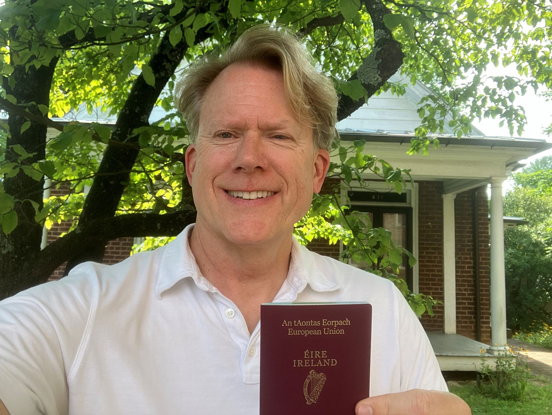 John Portmann holds his newly acquired Irish passport.