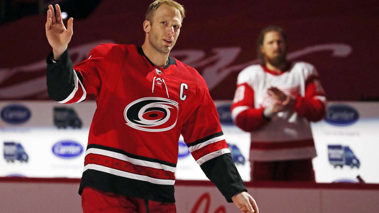 Carolina Hurricanes Jordan Staal (11) salutes the crowd with his brother Detroit Red Wings' Marc Staal (18) looking during a pregame ceremony recognizing his 1,000th NHL career game prior to the first period of an NHL hockey game between the Hurricanes and the Red Wings in Raleigh, N.C., Monday, April 12, 2021. NHL veteran Eric Staal is retiring after an 18-year career in the league.