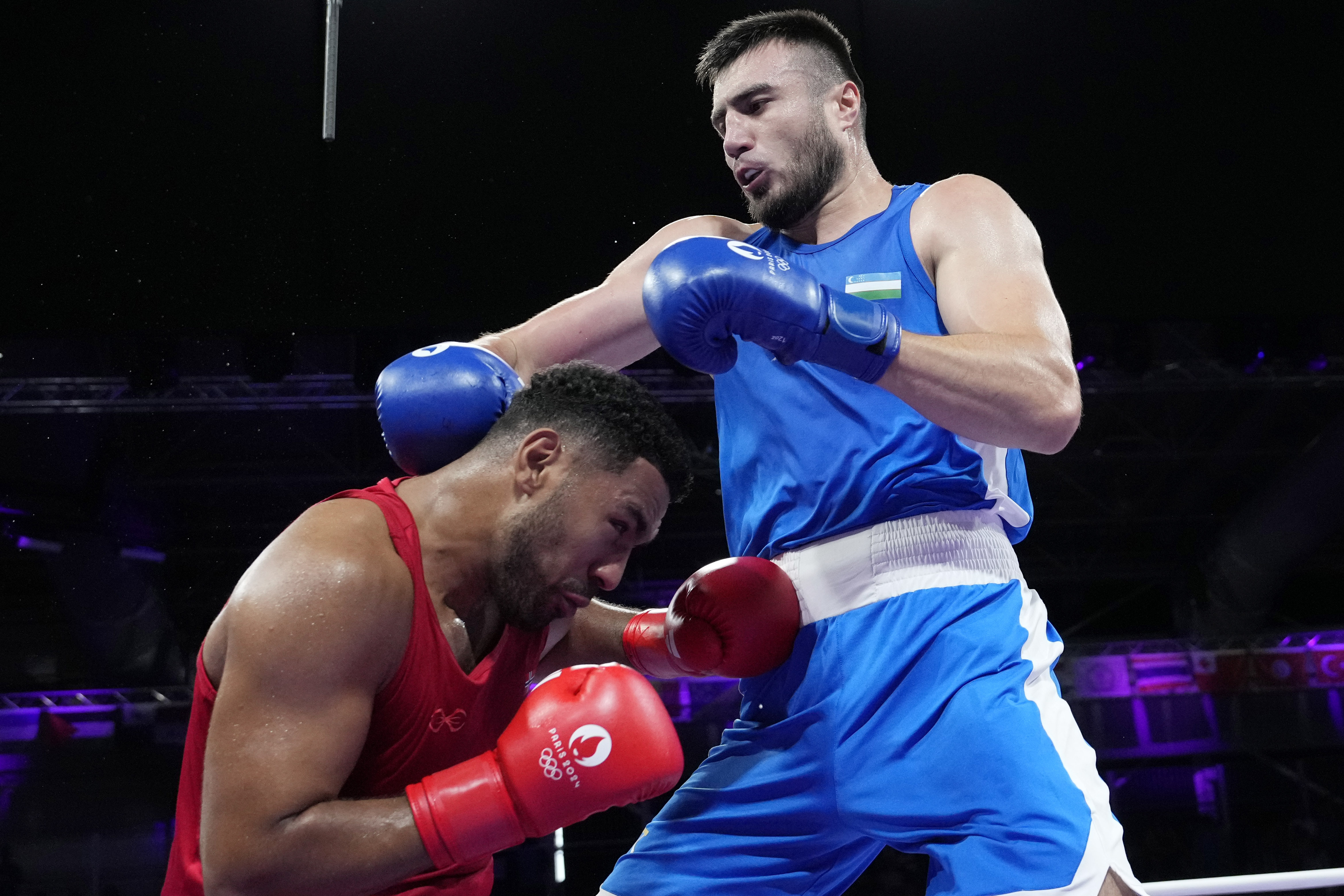 Uzbekistan's Bakhodir Jalolov hits Norway's Omar Shiha in their men's +92 kg preliminary boxing match at the 2024 Summer Olympics, Monday, July 29, 2024, in Paris, France. 