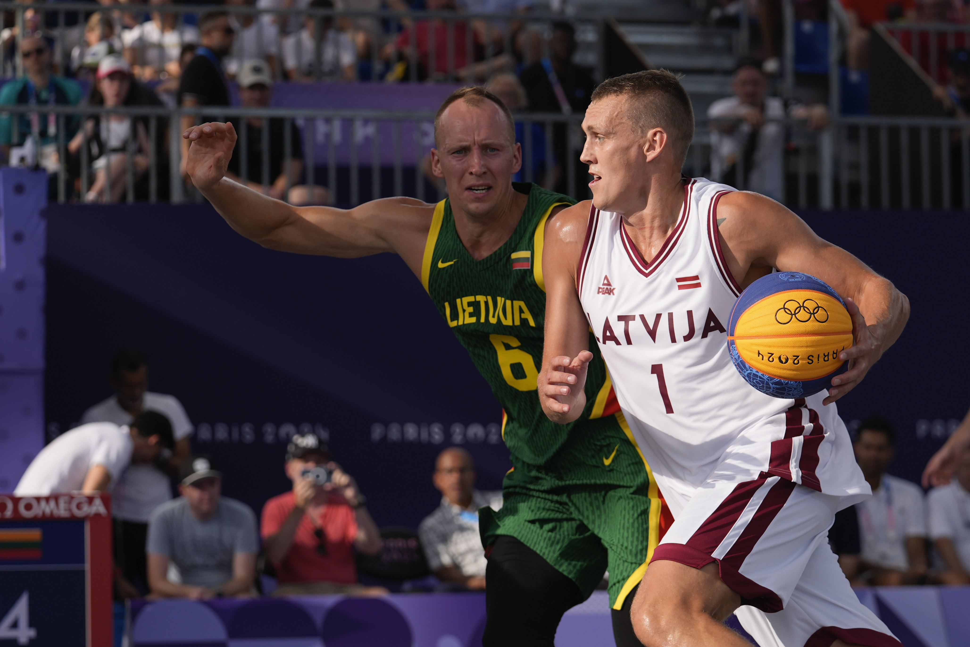 Nauris Miezis of Latvia drives past Gintautas Matulis of Lithuania in the men's 3x3 basketball pool round match between Latvia and Lithuania at the 2024 Summer Olympics, Tuesday, July 30, 2024, in Paris, France. 