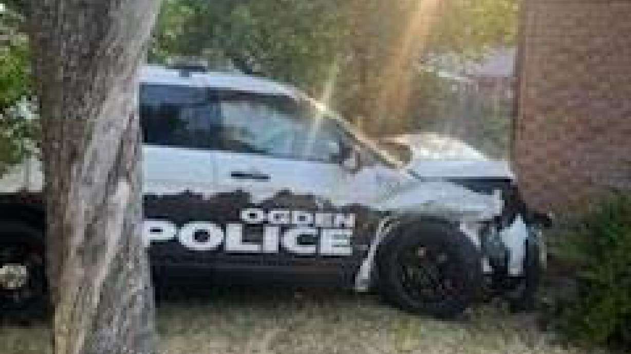 An Ogden police patrol car after hitting a building following a crash in a nearby intersection.