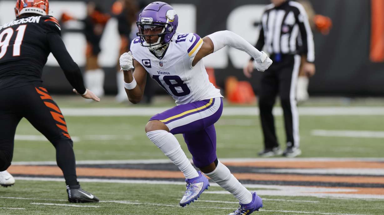FILE - Minnesota Vikings receiver Justin Jefferson plays against the Cincinnati Bengals during an NFL football game Saturday, Dec. 16, 2023, in Cincinnati. Professional sports teams across Ohio would be required to use playing surfaces of not less than 90% natural grass under legislation announced Tuesday, July 30, 2024.