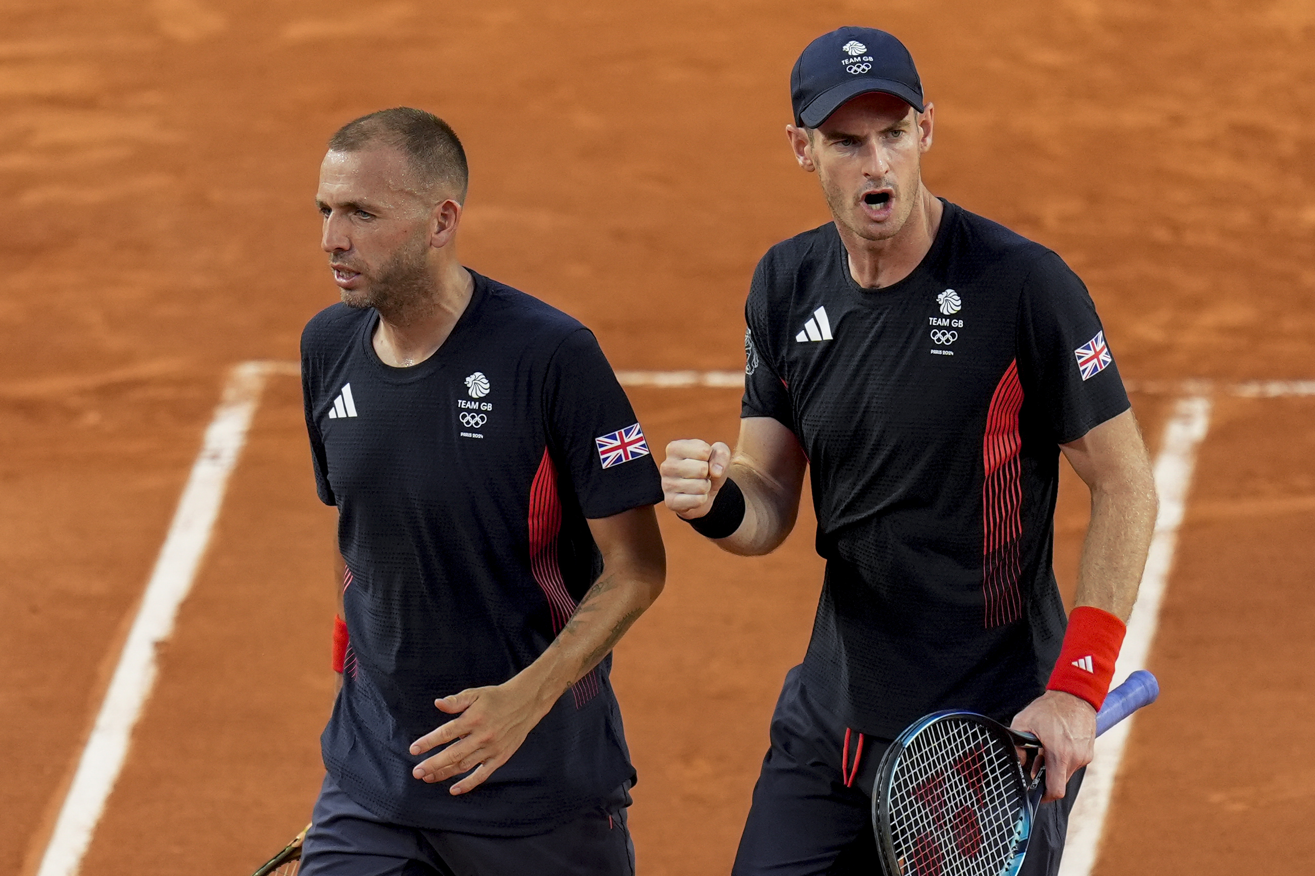 Andy Murray, right, and Daniel Evans of Britain celebrate a point during their match against Joran Vliegen and Sander Gille of Belgium during the men's doubles tennis competition at the Roland Garros stadium, at the 2024 Summer Olympics, Tuesday, July 30, 2024, in Paris, France. 