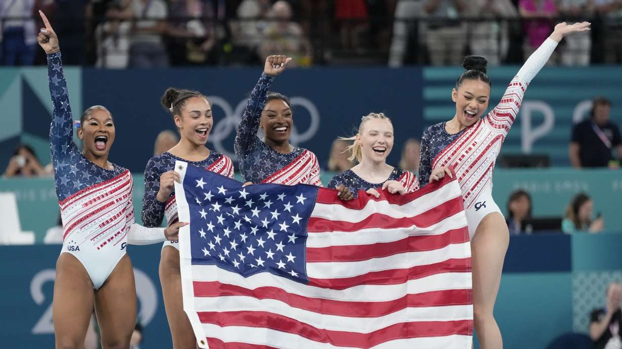Members of Team USA celebrate after winning the gold medal in the women's artistic gymnastics team finals round at Bercy Arena at the 2024 Summer Olympics, Tuesday, July 30, 2024, in Paris, France.