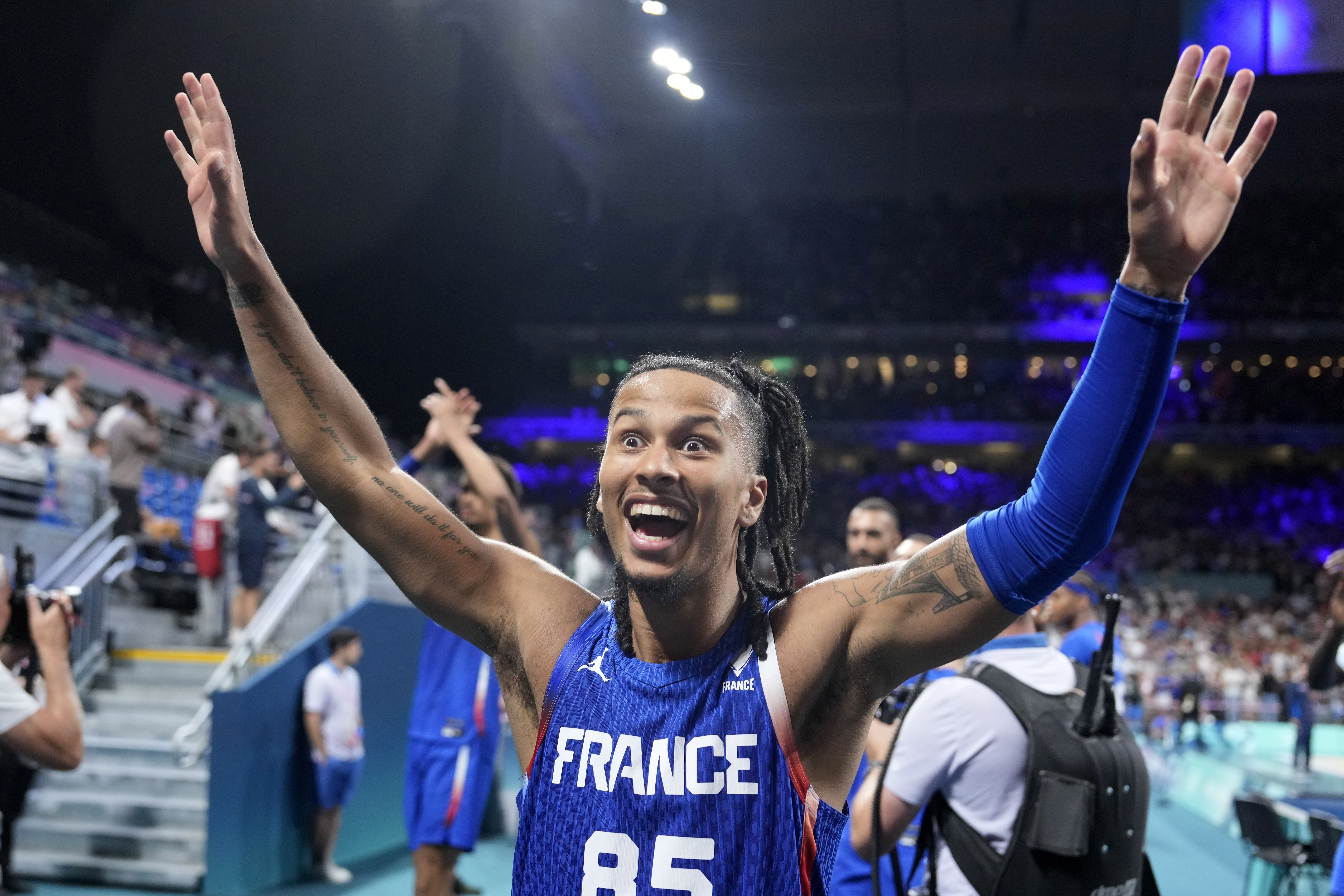 France's Matthew Strazel celebrates after France defeated Japan in a men's basketball game at the 2024 Summer Olympics, Tuesday, July 30, 2024, in Villeneuve-d'Ascq, France. 