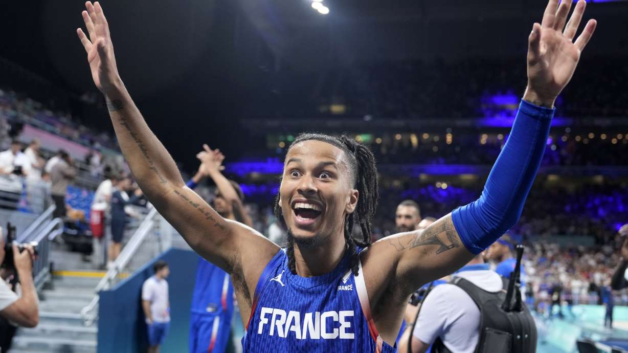 France's Matthew Strazel celebrates after France defeated Japan in a men's basketball game at the 2024 Summer Olympics, Tuesday, July 30, 2024, in Villeneuve-d'Ascq, France.