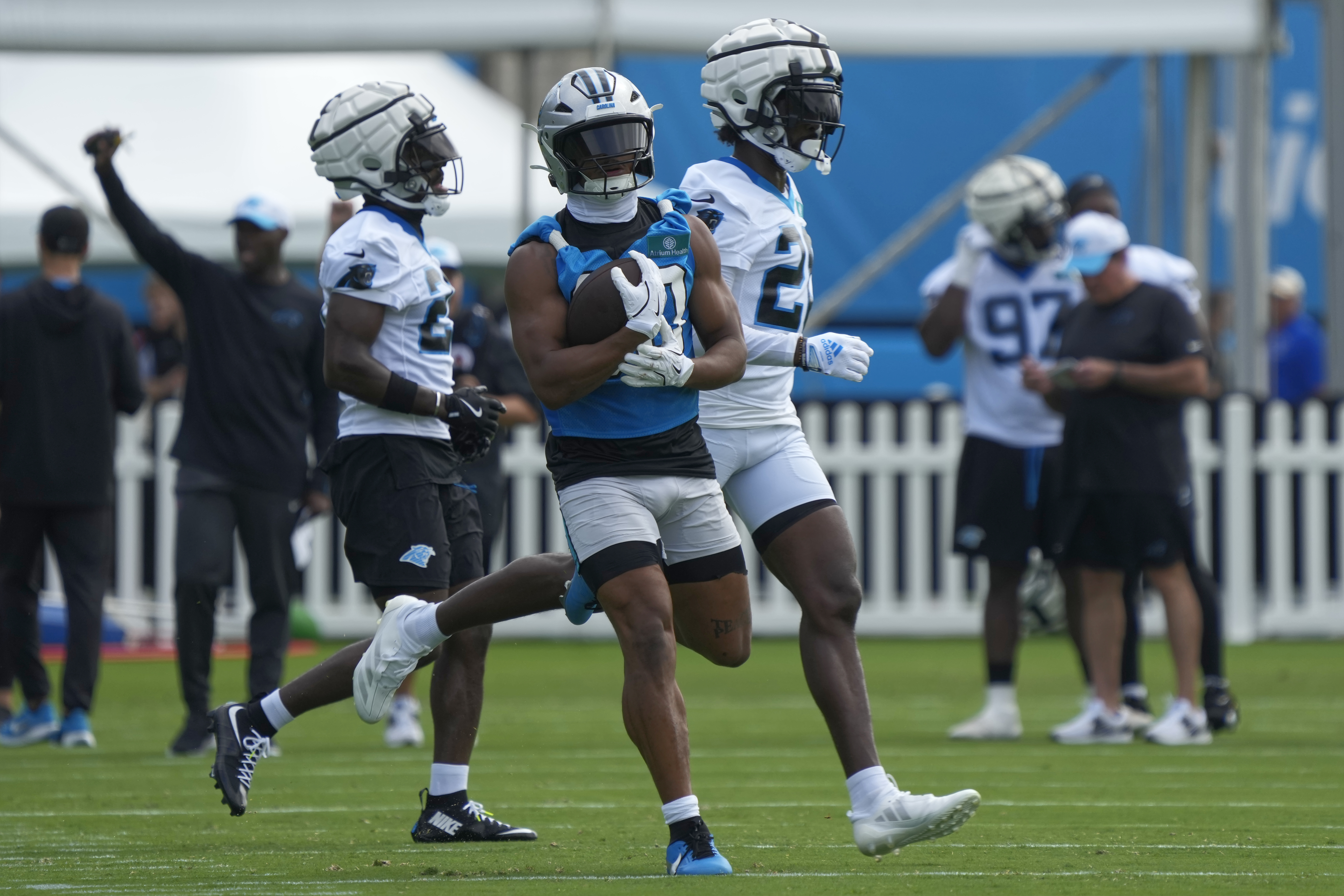 Carolina Panthers running back Chuba Hubbard, center, runs a drill during the NFL football team's training camp in Charlotte, N.C., Wednesday, July 24, 2024. 