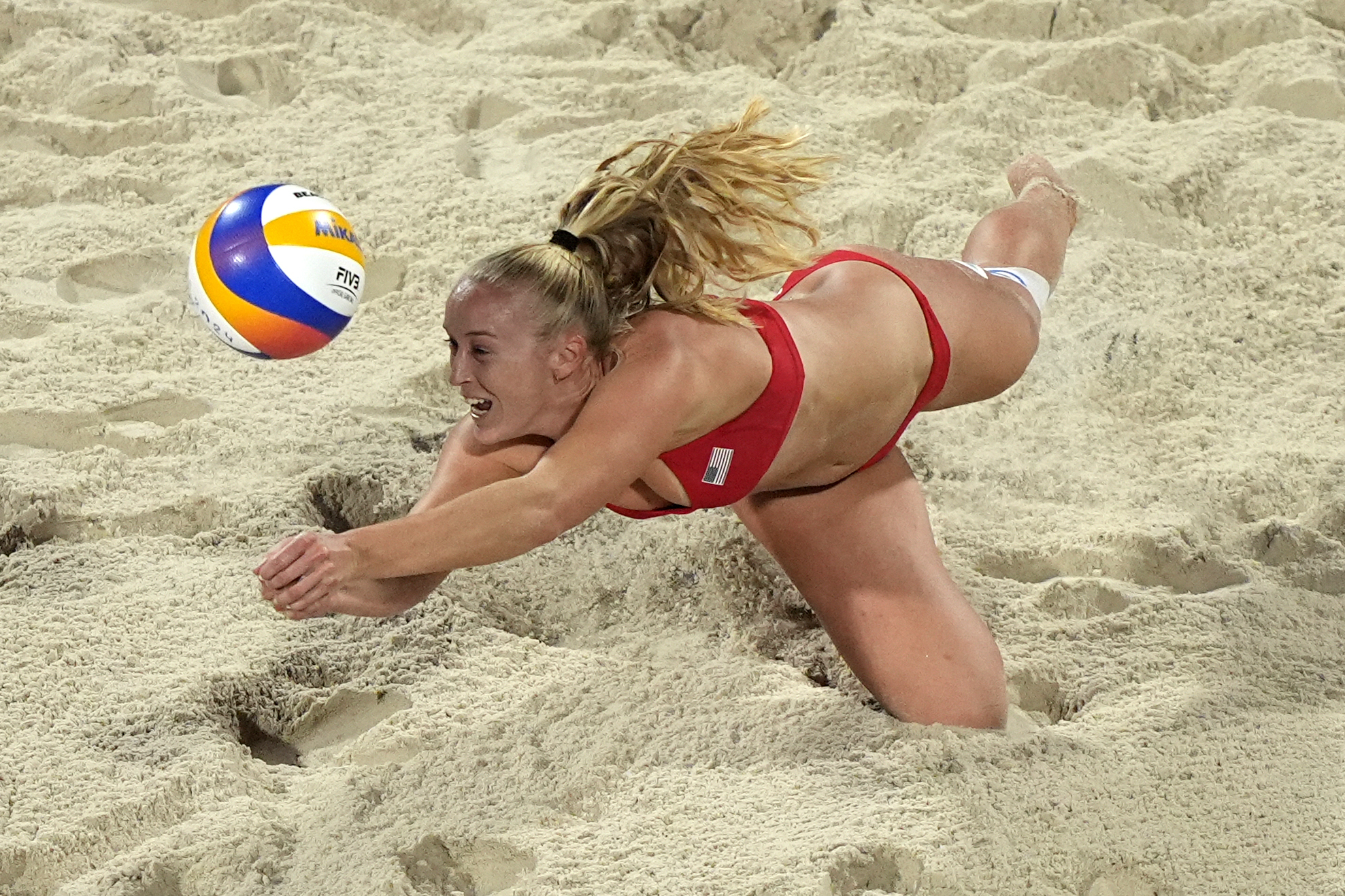 United States' Sara Hughes dives to return a shot against Czechia in a beach volleyball match at the 2024 Summer Olympics, Sunday, July 28, 2024, in Paris, France.