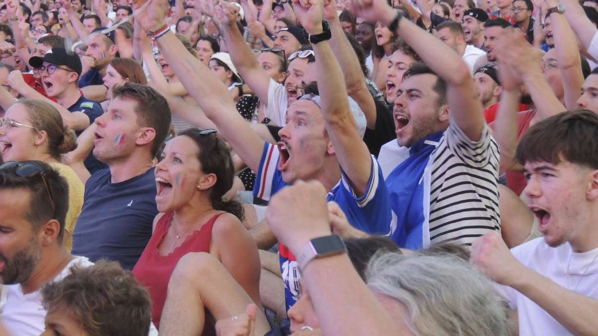 Fans cheer in Club France, an Olympic fan zone, in northern Paris, France, Tuesday, July 30, 2024.