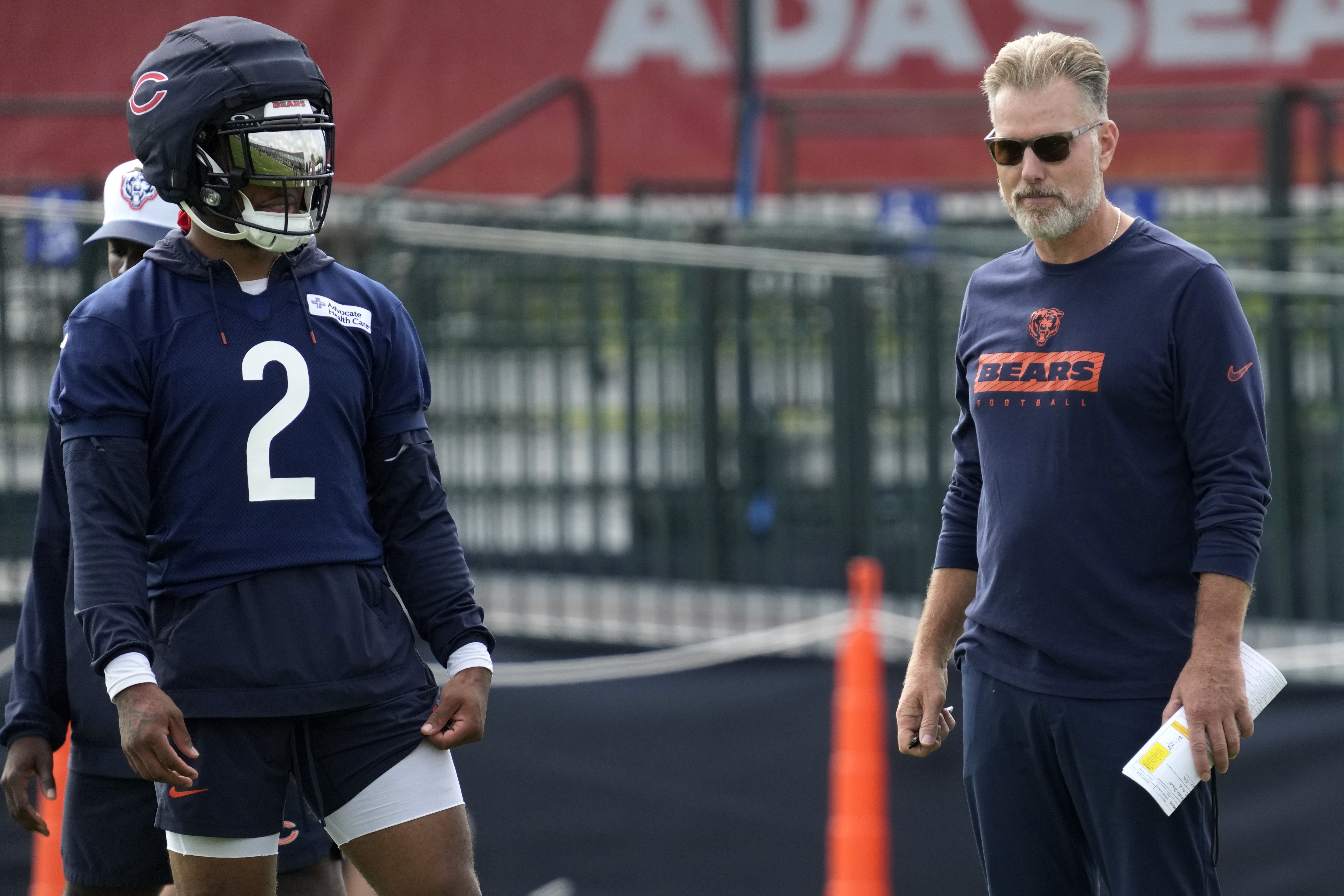 Chicago Bears wide receiver DJ Moore, left, watches teammates as head coach Matt Eberflus watches players during an NFL football training camp practice in Lake Forest, Ill., Monday, July 22, 2024. 