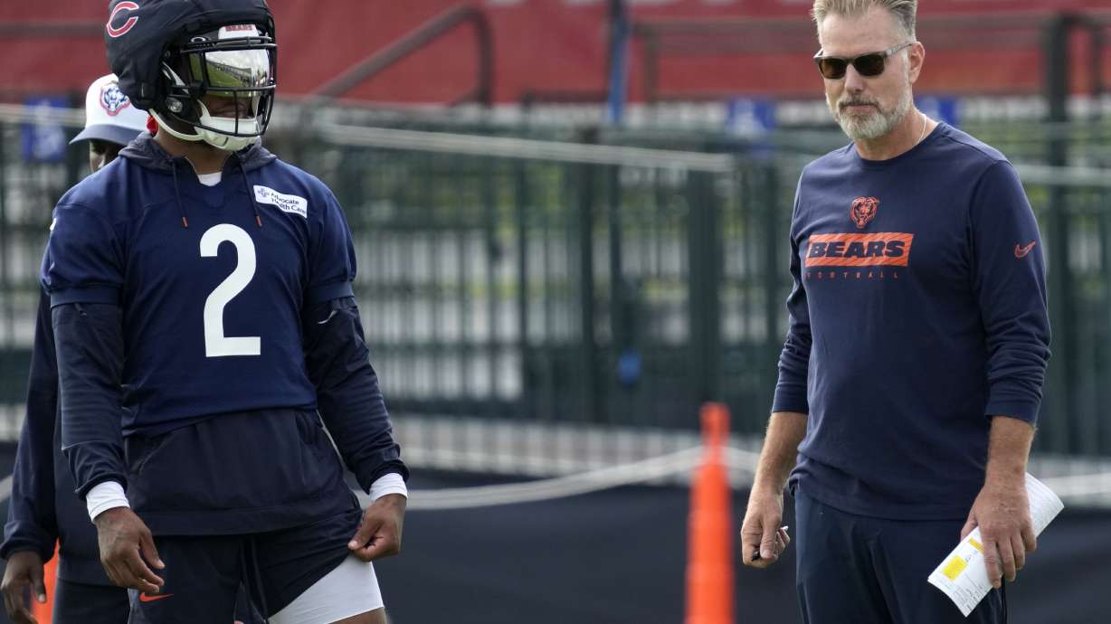 Chicago Bears wide receiver DJ Moore, left, watches teammates as head coach Matt Eberflus watches players during an NFL football training camp practice in Lake Forest, Ill., Monday, July 22, 2024.