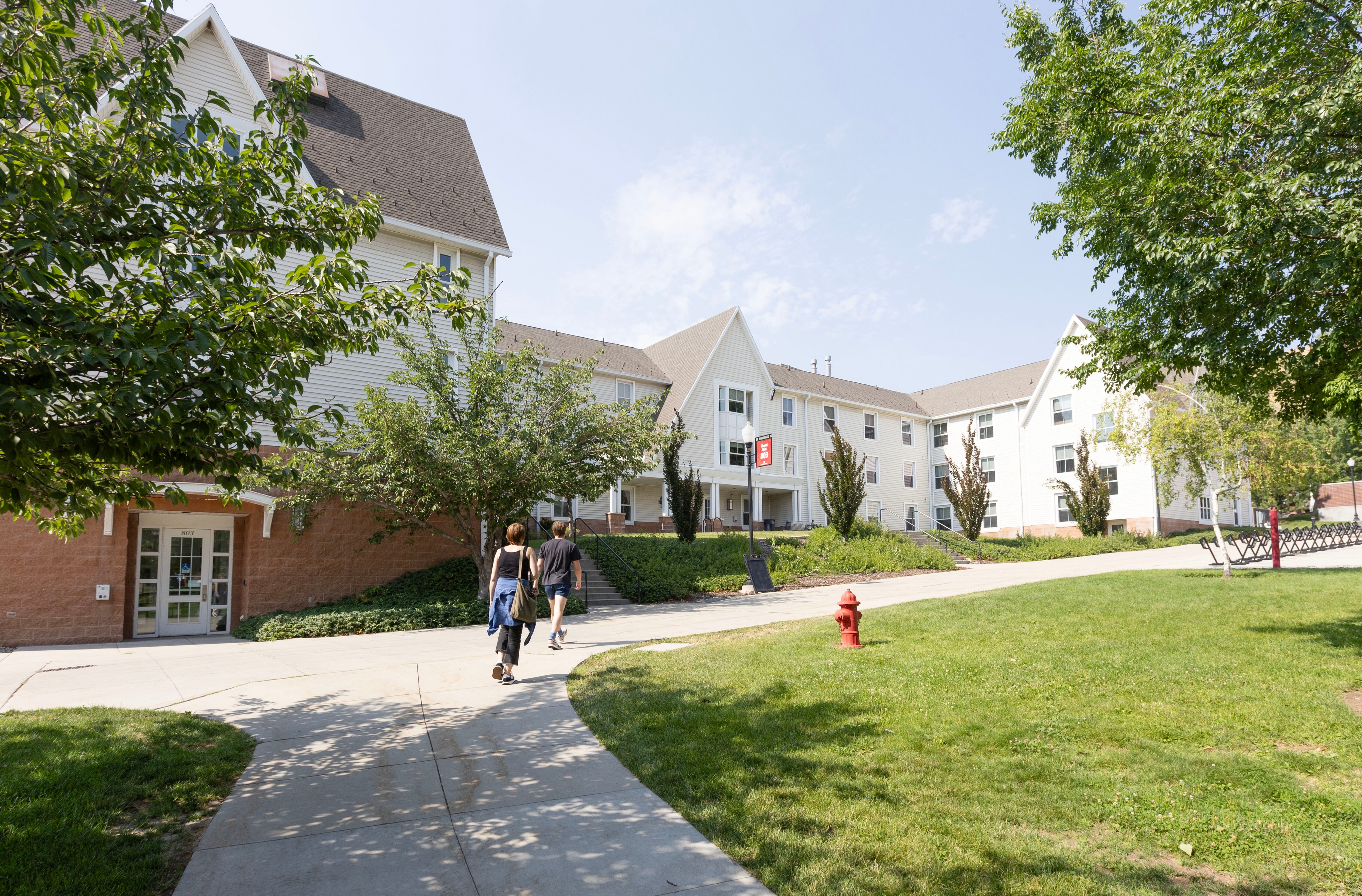 Jen Cain and her son Jude Cain, tour the Chapel Glen residence halls, which were a part of the 2002 Olympic Village at the University of Utah in Salt Lake City on Tuesday. The university's president was struck by the size of the athlete housing in Paris.