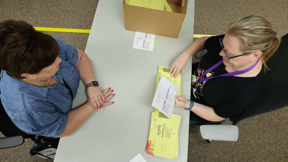 Lt. Governor representative Rozan Mitchell, left, observes Shemia Splonskowski reviewing postmarks at the Salt Lake County Clerk's office begin recounting the Colby Jenkins and Rep. Celeste Maloy race ballots in Salt Lake City on Tuesday. Jenkins has filed a petition with the Utah Supreme Court to challenge the certification.