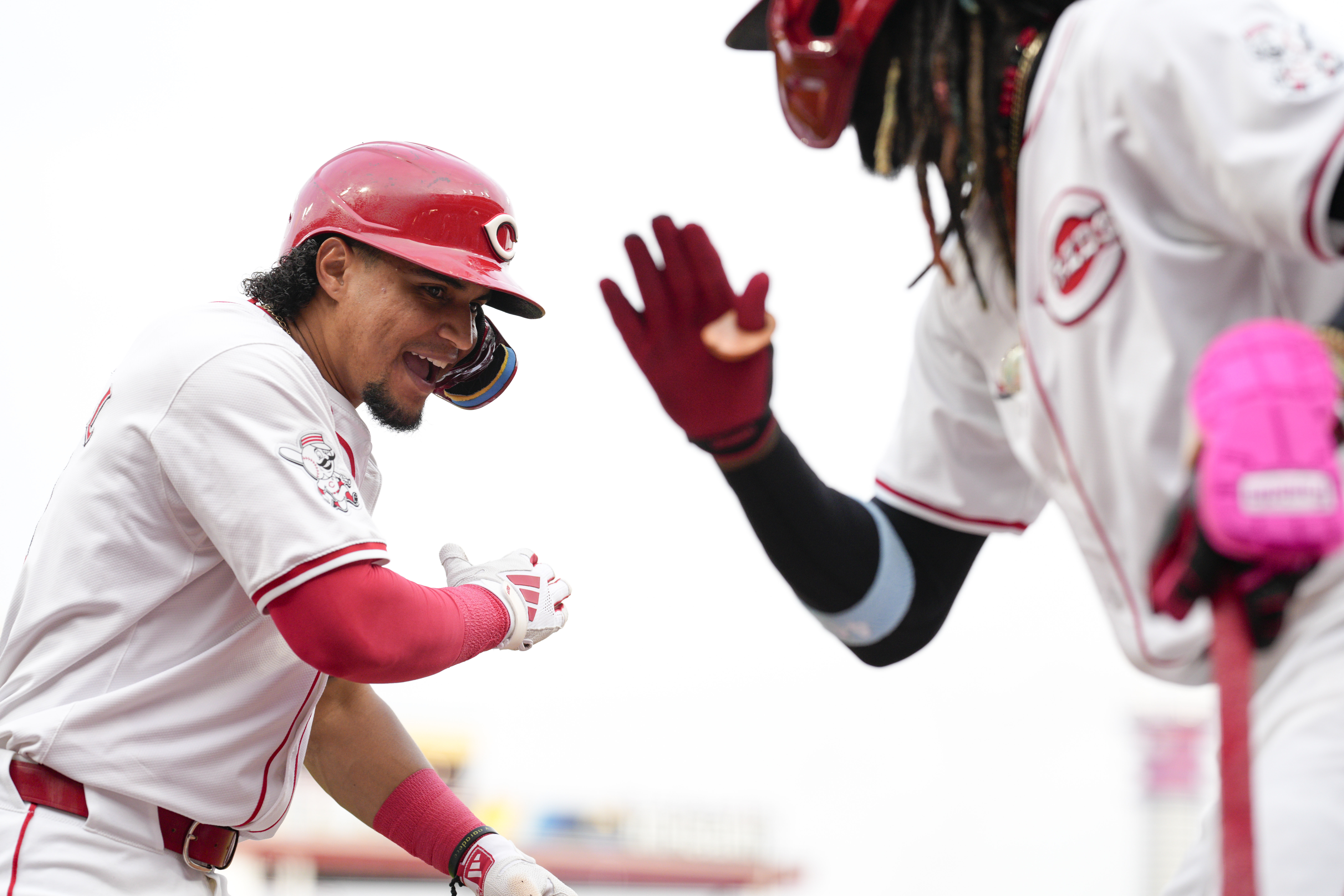 Cincinnati Reds' Santiago Espinal, left, celebrates with teammate Elly De La Cruz after hitting a two-run home run during the second inning of a baseball game against the Chicago Cubs, Tuesday, July 30, 2024, in Cincinnati. 