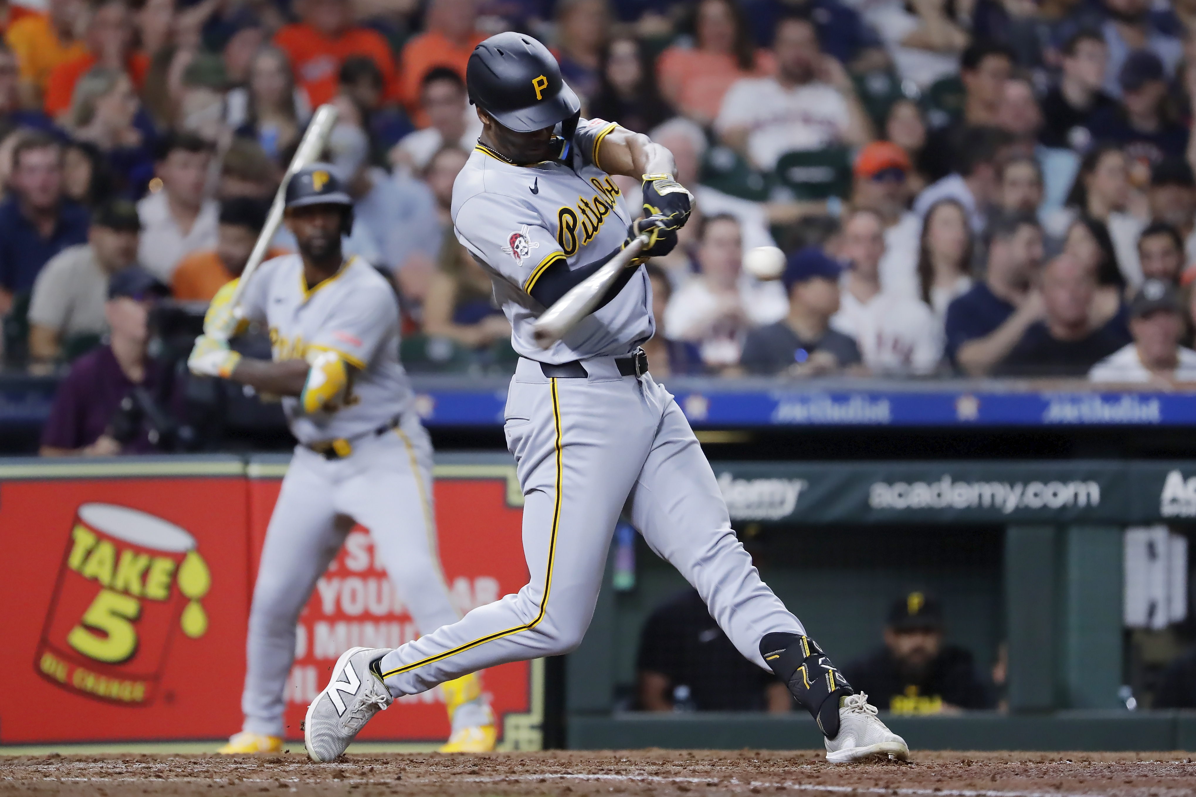 Pittsburgh Pirates' Michael A. Taylor, right, swings on his two-run home run as Andrew McCutchen, left, looks on during the sixth inning of a baseball game against the Houston Astros, Tuesday, July 30, 2024, in Houston. 