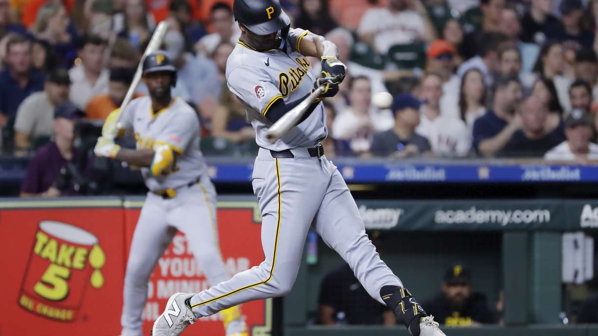 Pittsburgh Pirates' Michael A. Taylor, right, swings on his two-run home run as Andrew McCutchen, left, looks on during the sixth inning of a baseball game against the Houston Astros, Tuesday, July 30, 2024, in Houston.