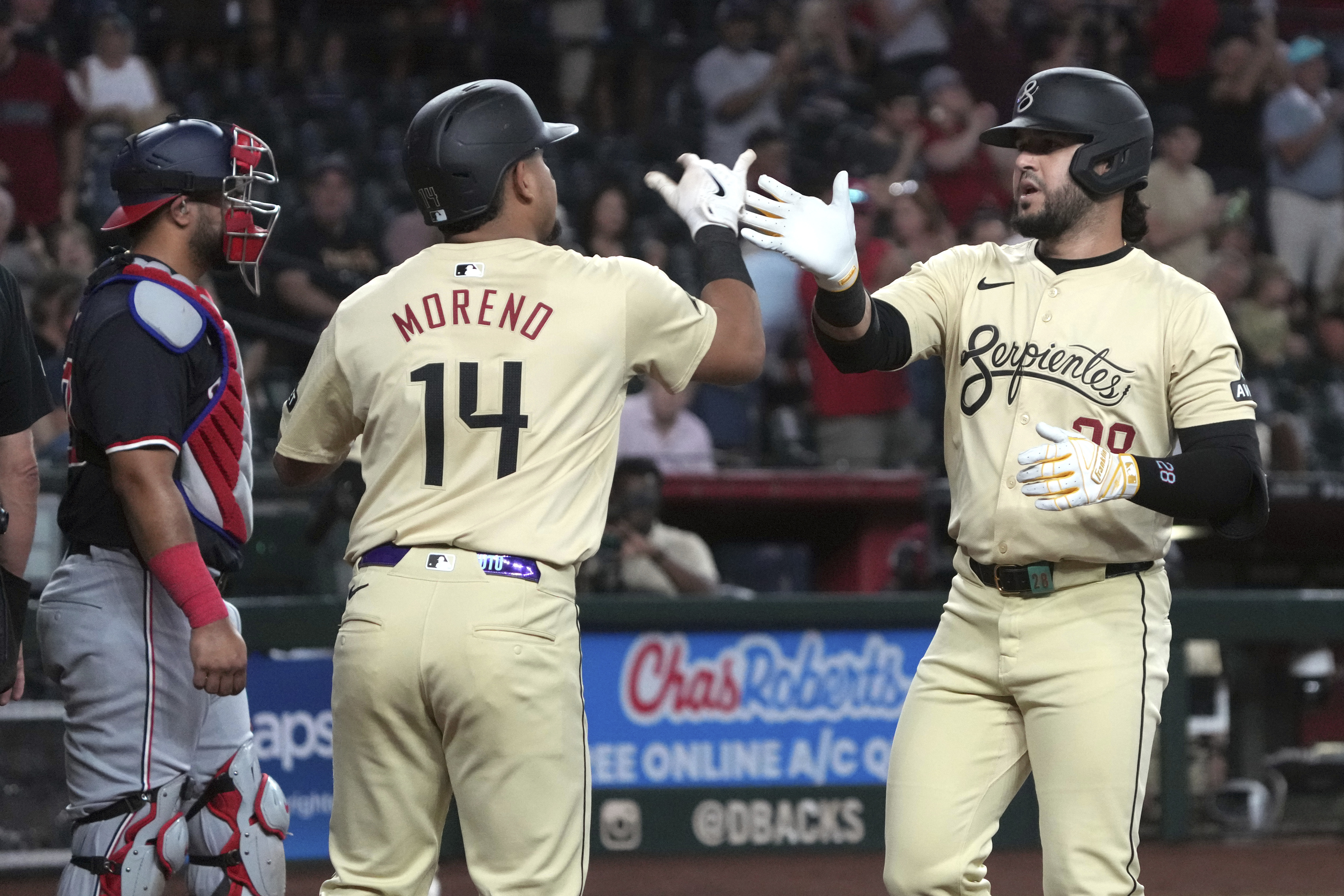 Arizona Diamondbacks' Eugenio Suárez celebrates with Gabriel Moreno (14) after hitting a two-run home run against the Washington Nationals in the first inning during a baseball game, Tuesday, July 30, 2024, in Phoenix. 