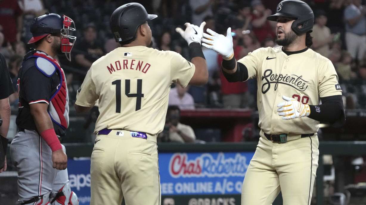 Arizona Diamondbacks' Eugenio Suárez celebrates with Gabriel Moreno (14) after hitting a two-run home run against the Washington Nationals in the first inning during a baseball game, Tuesday, July 30, 2024, in Phoenix.