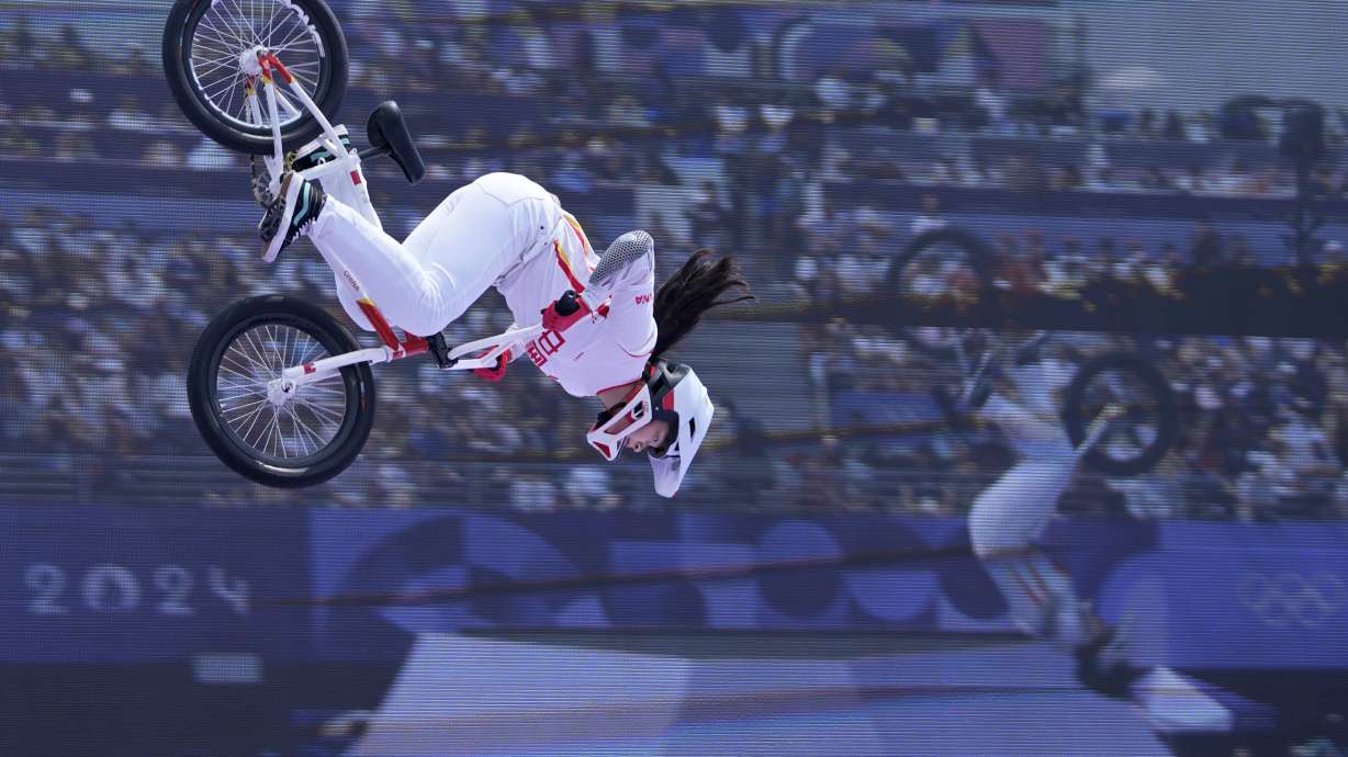 Deng Yawen, of China, performs a trick in front of a video screen during the cycling BMX freestyle women's park final at the 2024 Summer Olympics, Wednesday, July 31, 2024, in Paris, France.