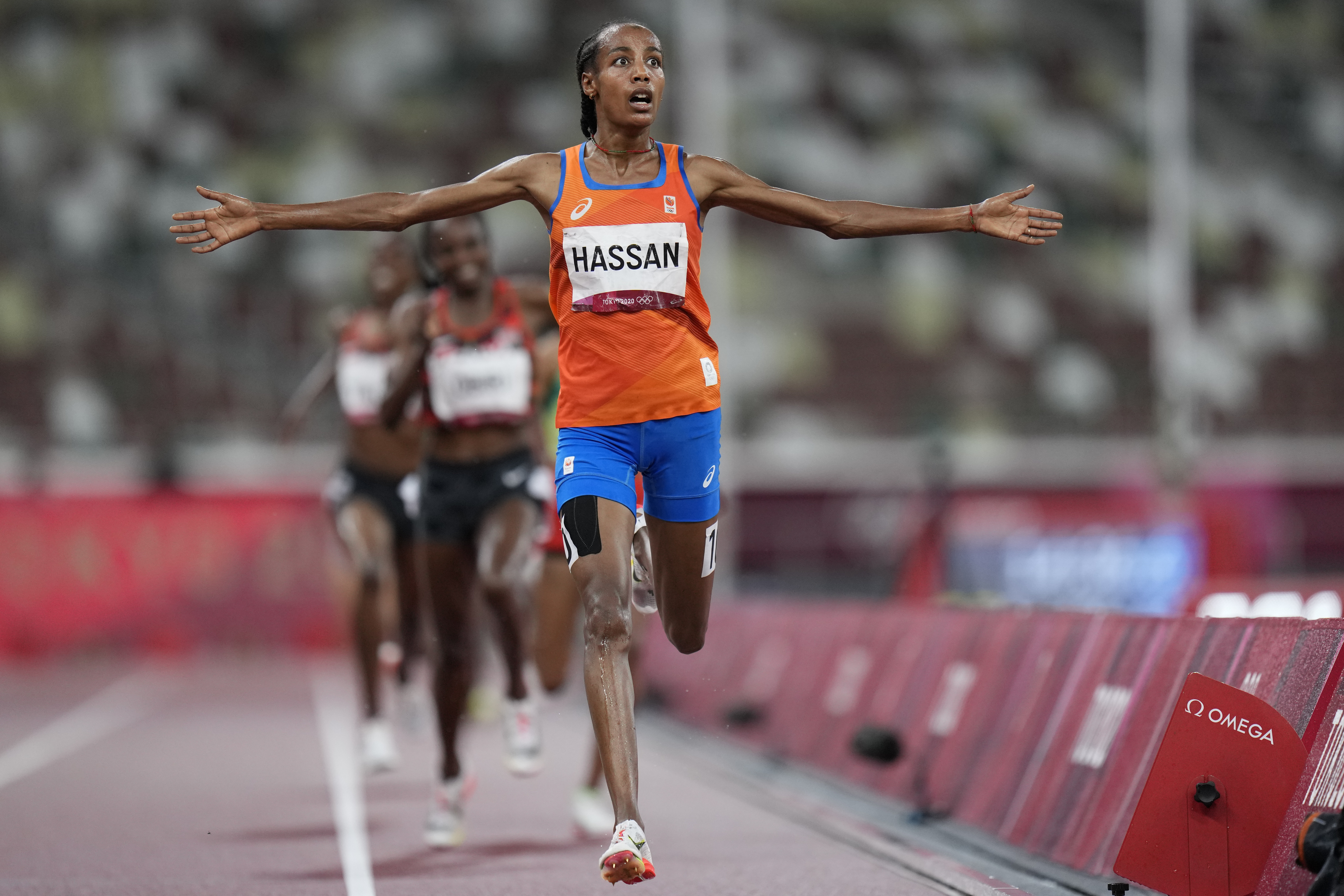 FILE - Sifan Hassan, of the Netherlands, celebrates as she crosses the finish line to win the women's 5,000-meters final at the 2020 Summer Olympics, Monday, Aug. 2, 2021, in Tokyo. 