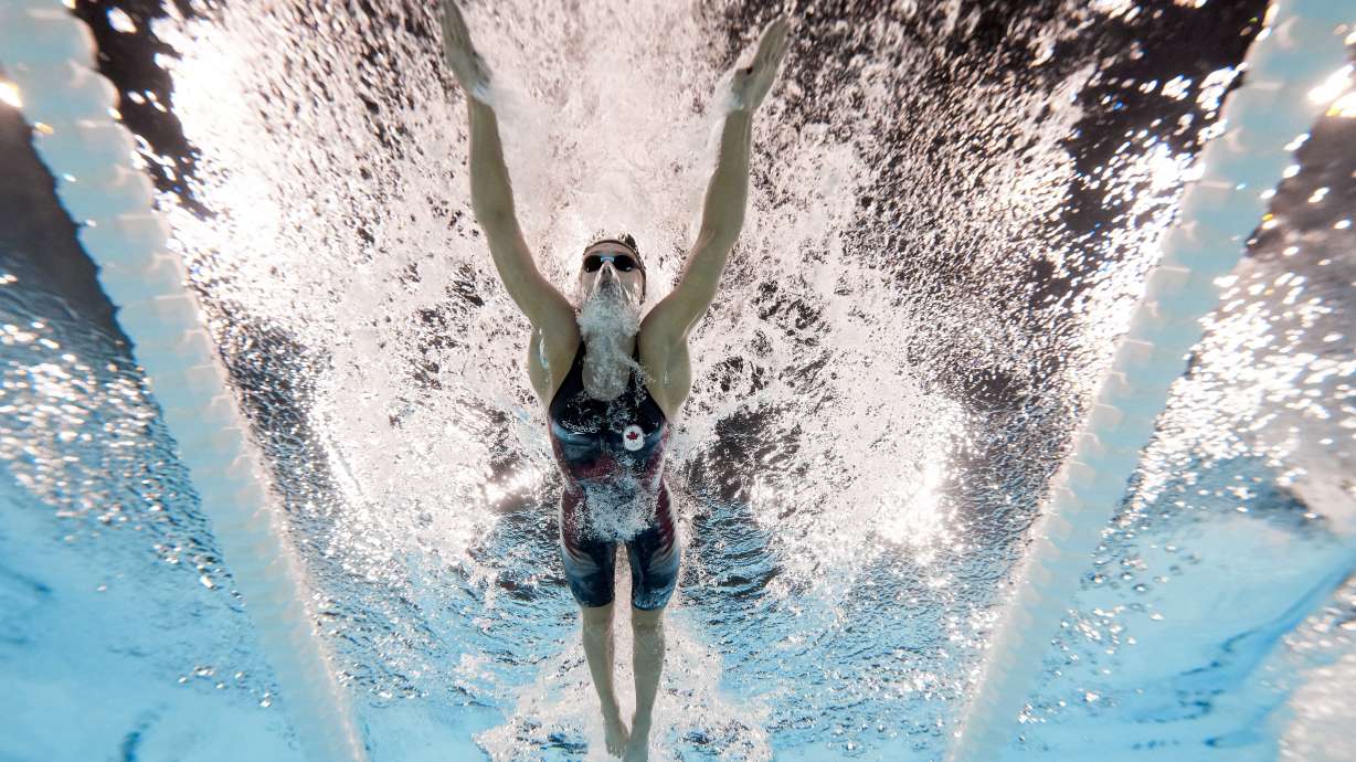 Summer McIntosh, of Canada, competes during a heat in the women's 200-meter butterfly at the 2024 Summer Olympics, Wednesday, July 31, 2024, in Nanterre, France.
