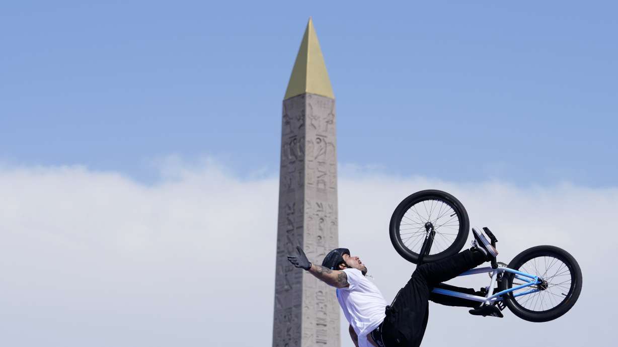 Gil Jose Torres, of Argentina, performs a trick, with the Luxor Obelisk of La Concorde square in the background, during the cycling BMX freestyle women's park final at the 2024 Summer Olympics, Wednesday, July 31, 2024, in Paris, France.