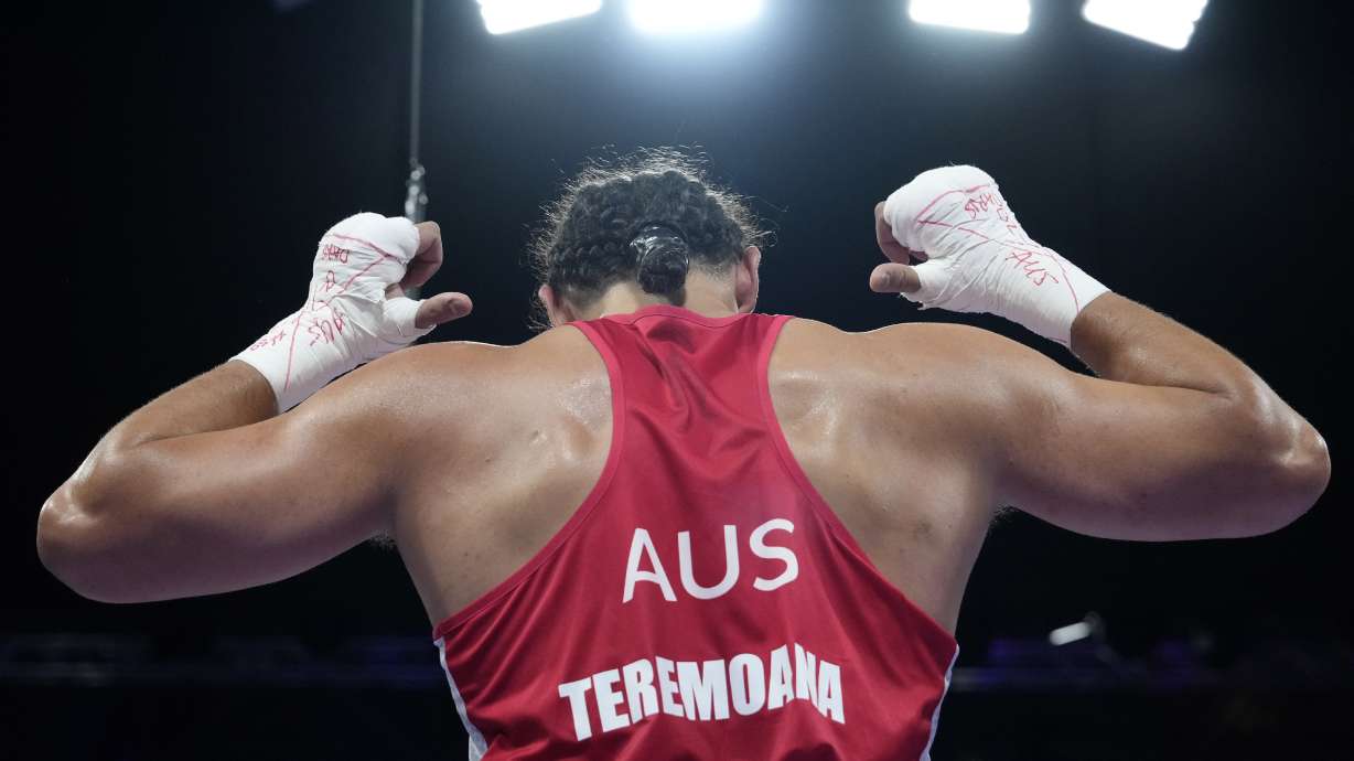 Australia's Teremoana Teremoana celebrates after defeating Ukraine's Dmytro Lovchynskyi in their men's +92 kg preliminary boxing match at the 2024 Summer Olympics, Monday, July 29, 2024, in Paris, France.