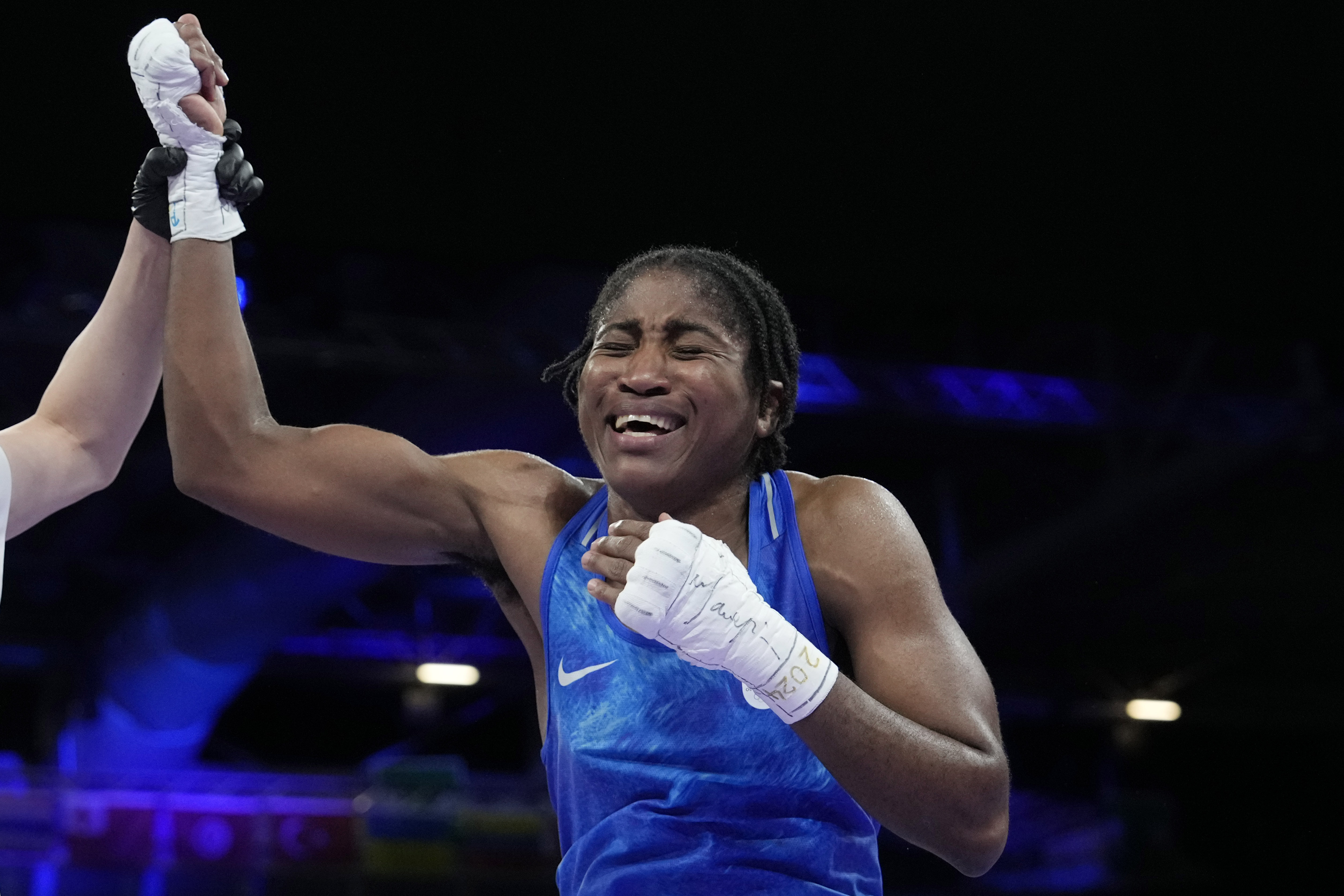 Refugee Olympic Team's Cindy Djankeu celebrates after defeating Canada's Tammara Thibeault in their women's 75 kg preliminary boxing match at the 2024 Summer Olympics, Wednesday, July 31, 2024, in Paris, France.
