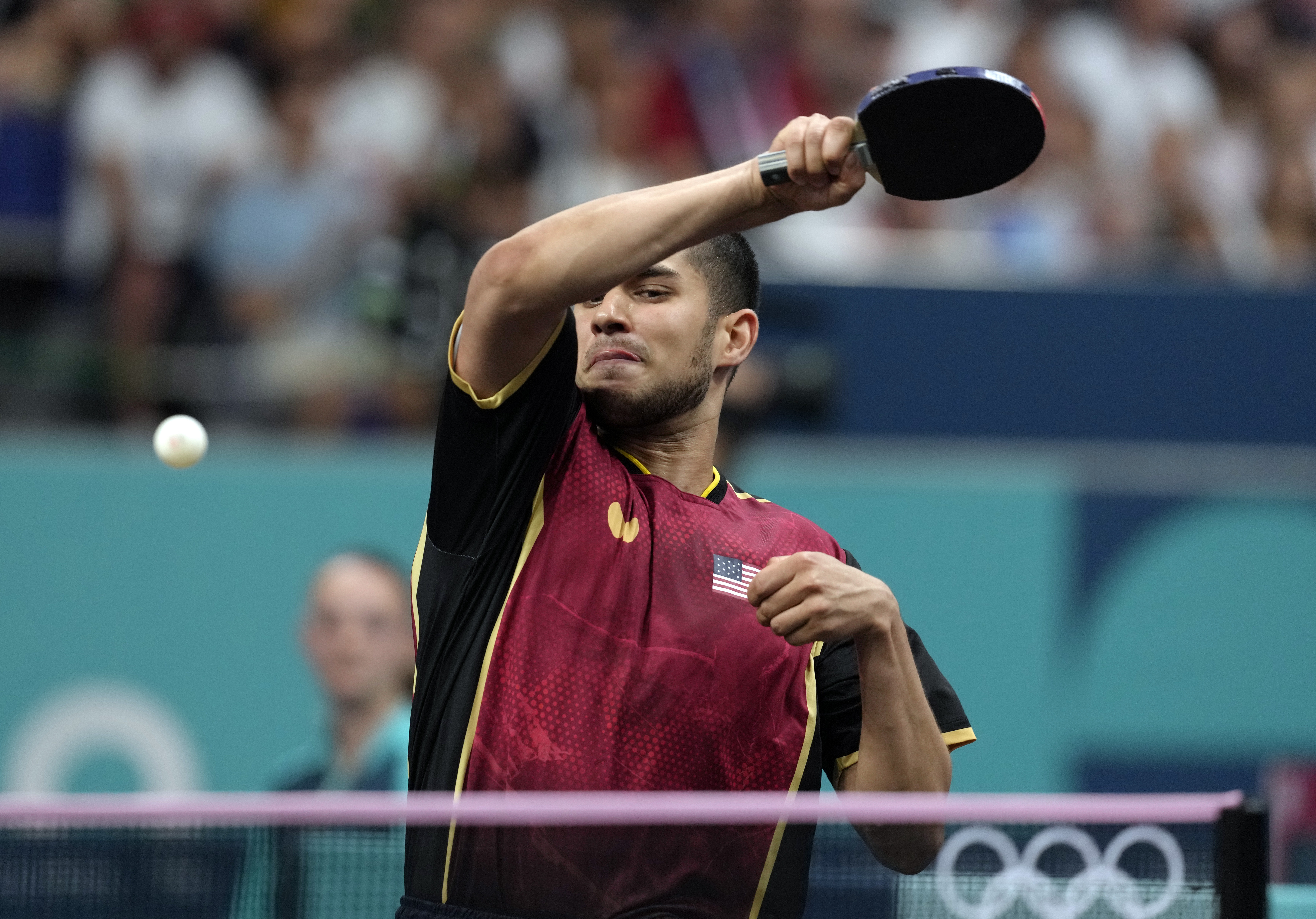 United States' Kanak Jha plays against Greece's Panagiotis Gionis during a men's singles round of 32 table tennis game at the 2024 Summer Olympics, Wednesday, July 31, 2024, in Paris, France. 