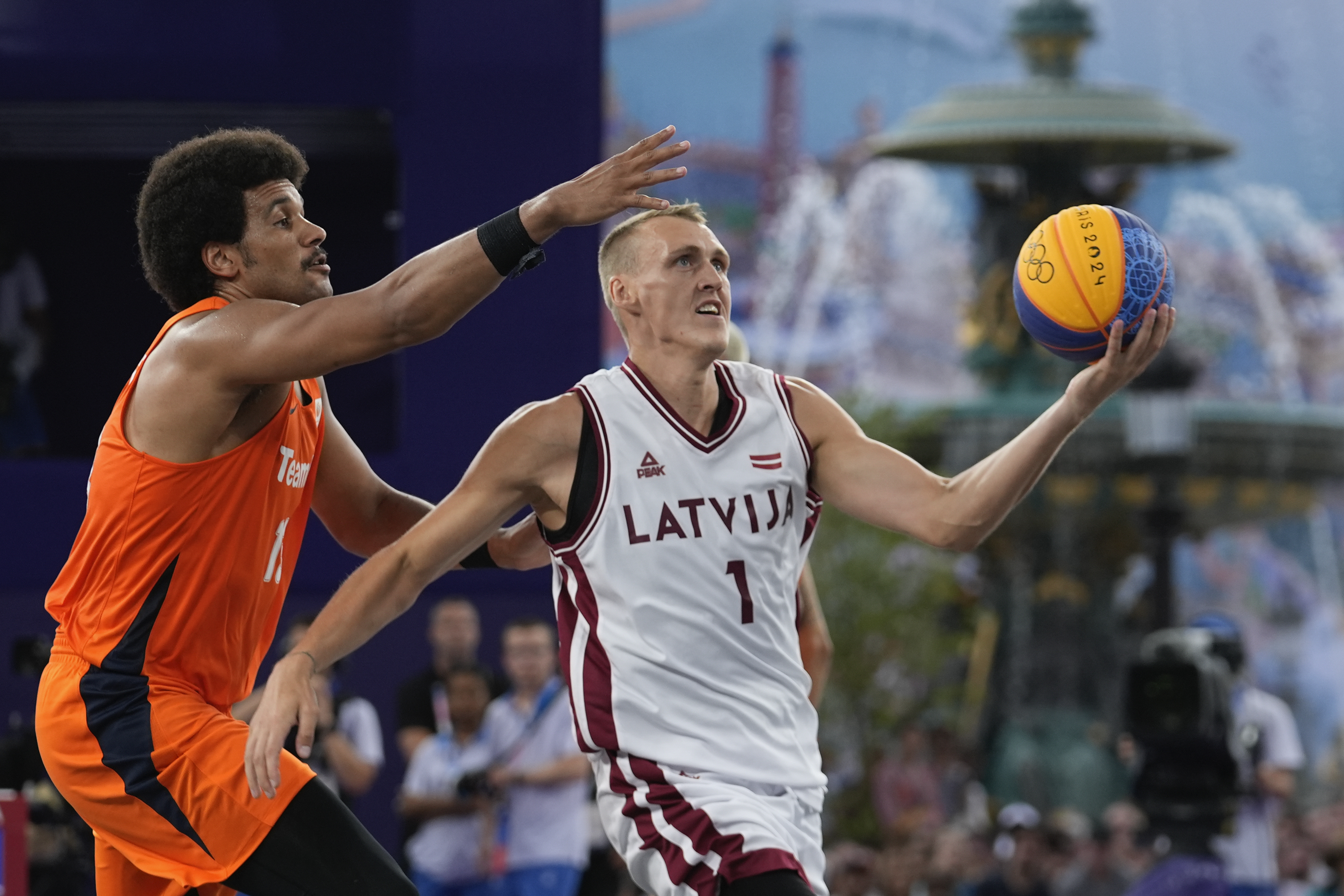 Latvia's Nauris Miezis carries the ball defended by Dimeo van der Horst of the Netherlands in the men's 3x3 basketball pool round match between Latvia and the Netherlands at the 2024 Summer Olympics, Wednesday, July 31, 2024, in Paris, France. 