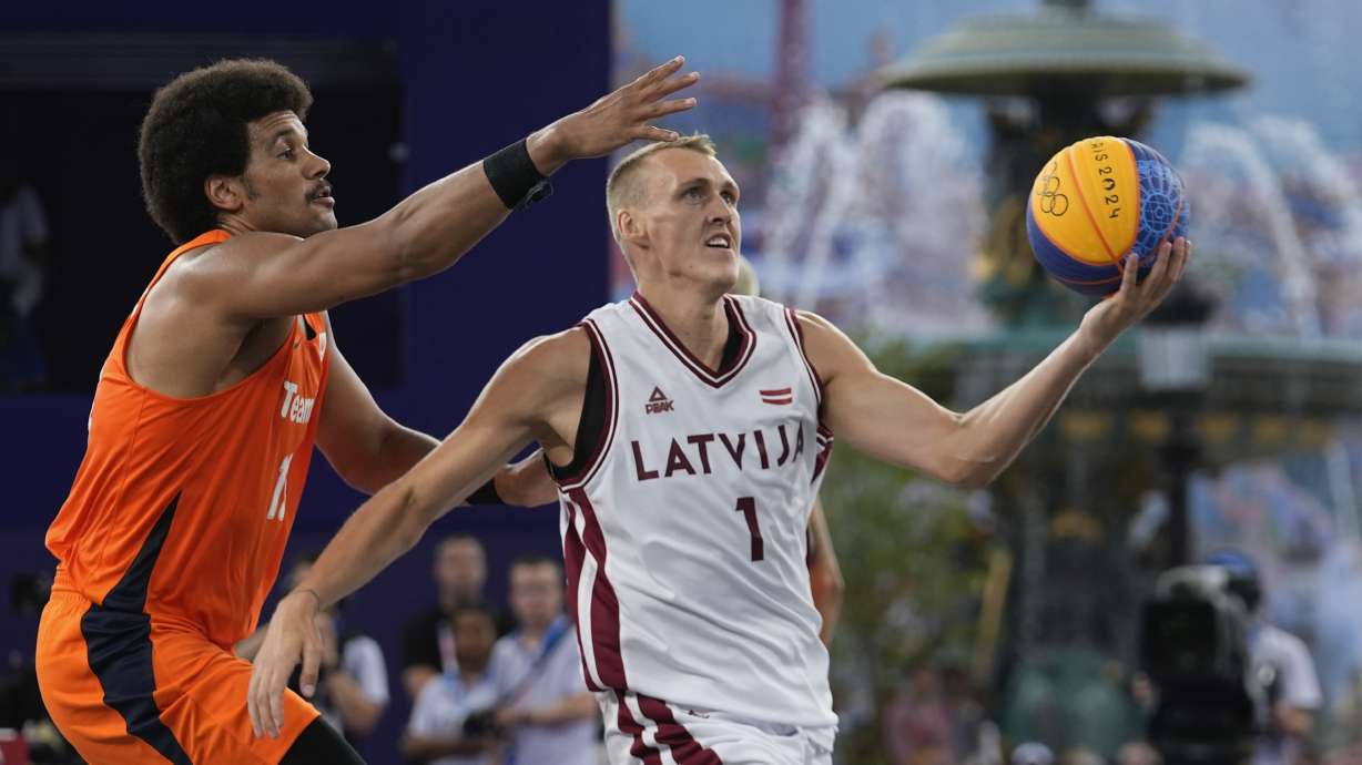 Latvia's Nauris Miezis carries the ball defended by Dimeo van der Horst of the Netherlands in the men's 3x3 basketball pool round match between Latvia and the Netherlands at the 2024 Summer Olympics, Wednesday, July 31, 2024, in Paris, France.