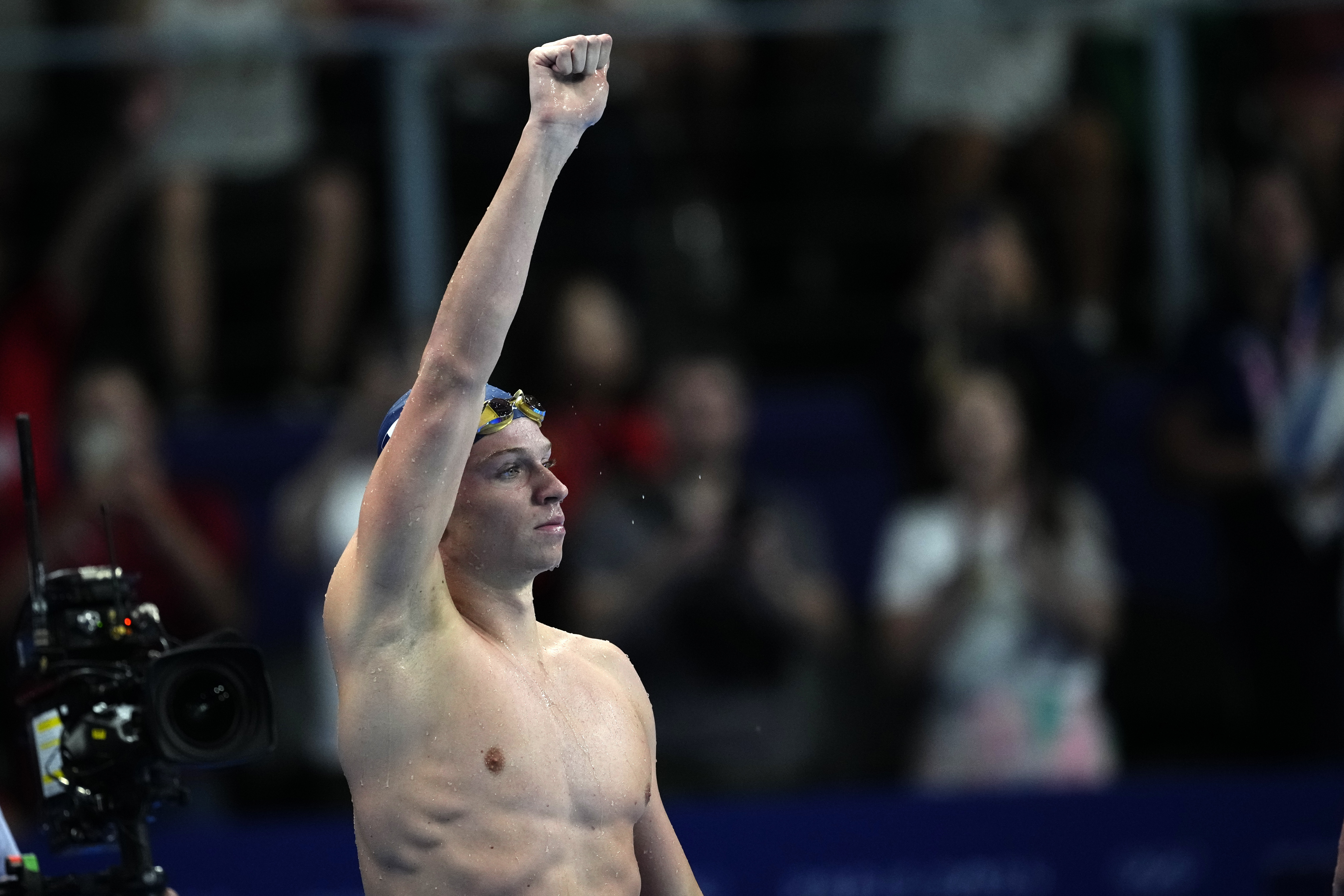 Leon Marchand, of France, celebrates after winning the men's 200-meter butterfly final at the 2024 Summer Olympics, Wednesday, July 31, 2024, in Nanterre, France.